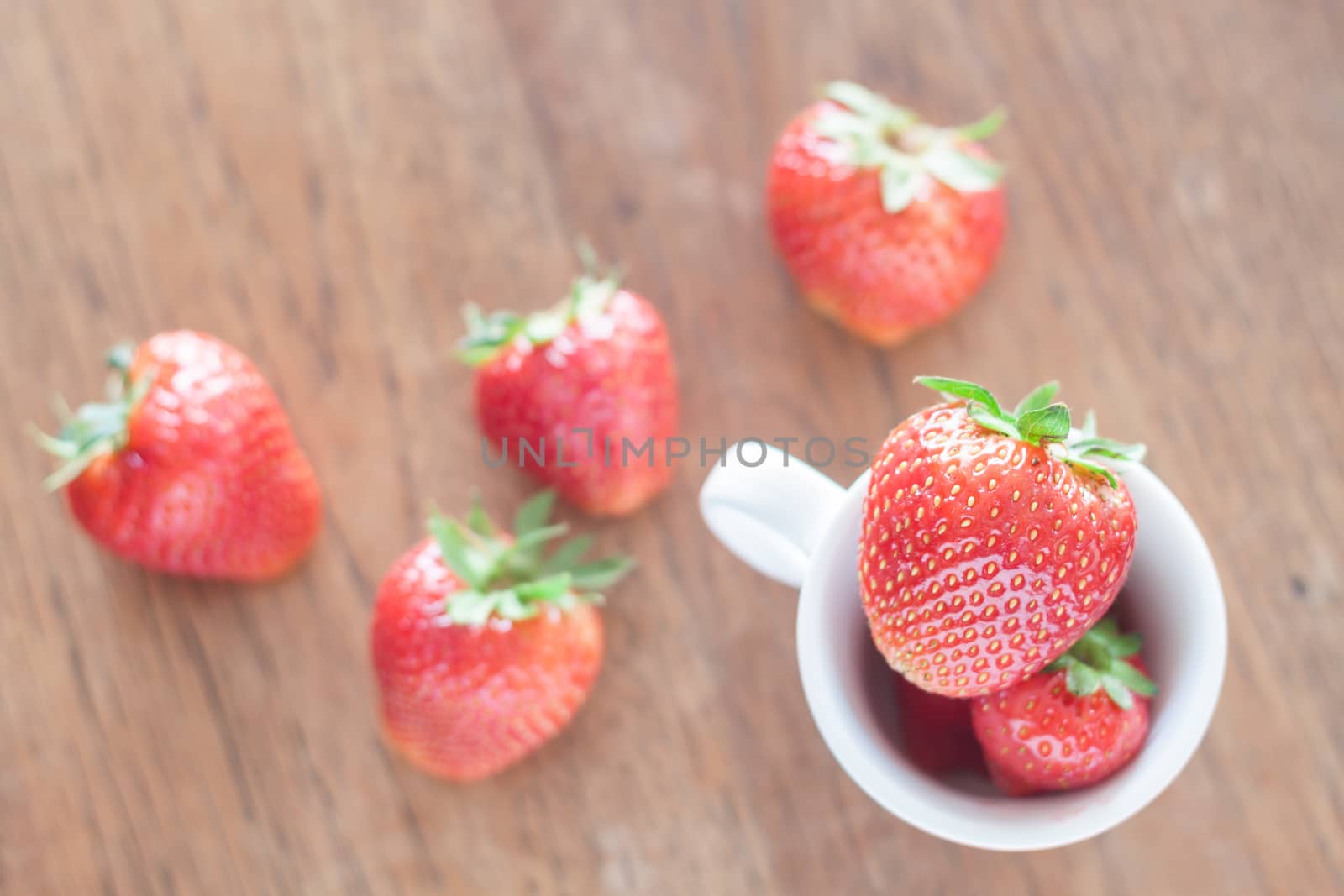Fresh strawberries on wooden table, stock photo