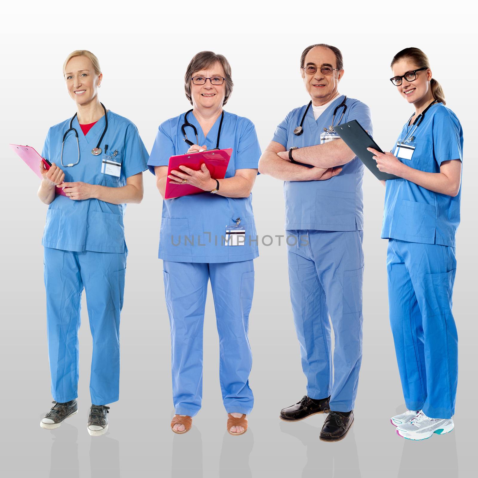 Senior team of doctors posing with a smile by stockyimages