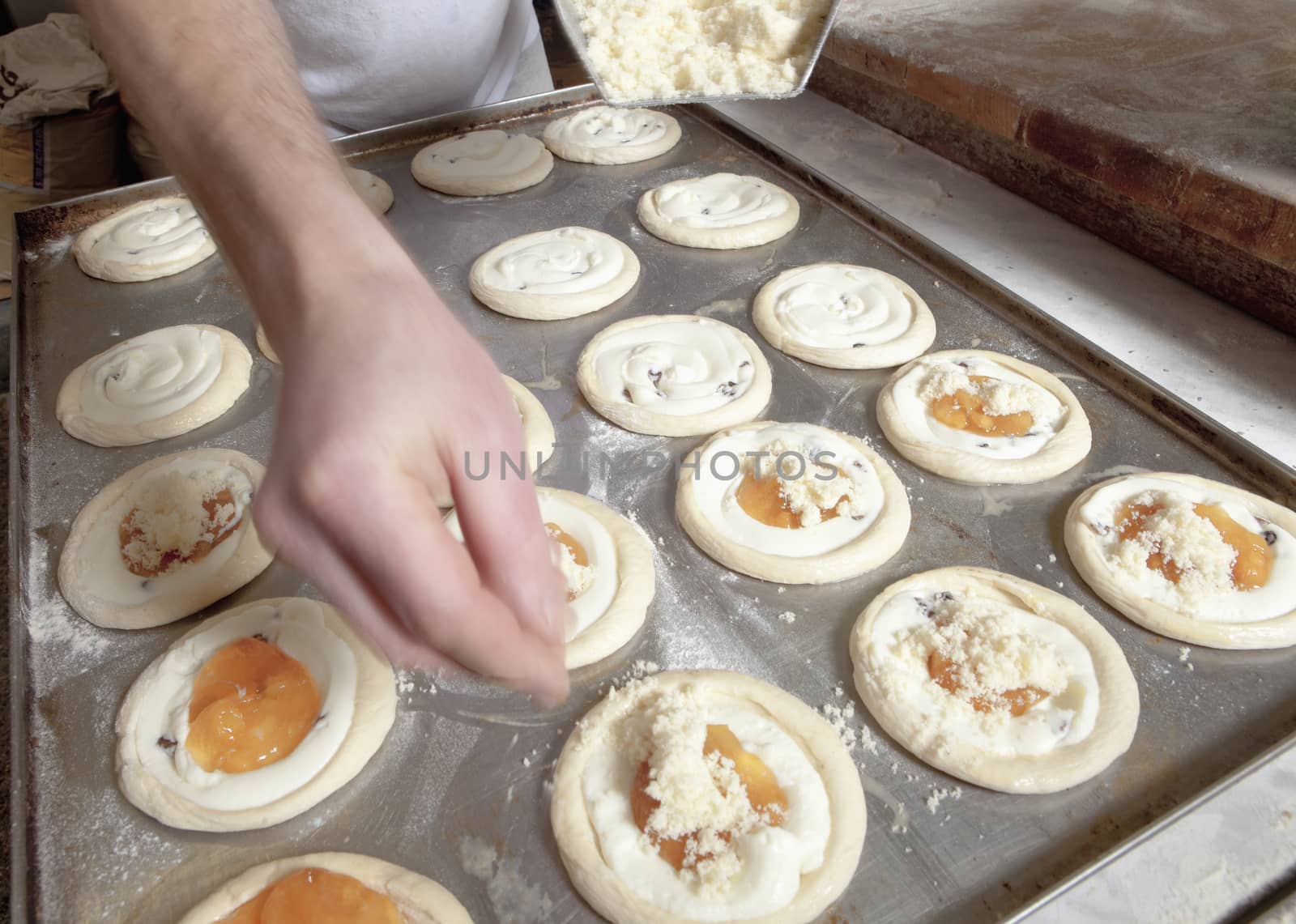 Professional Bakery - Adding Cheese on Top of Pastry before Baking