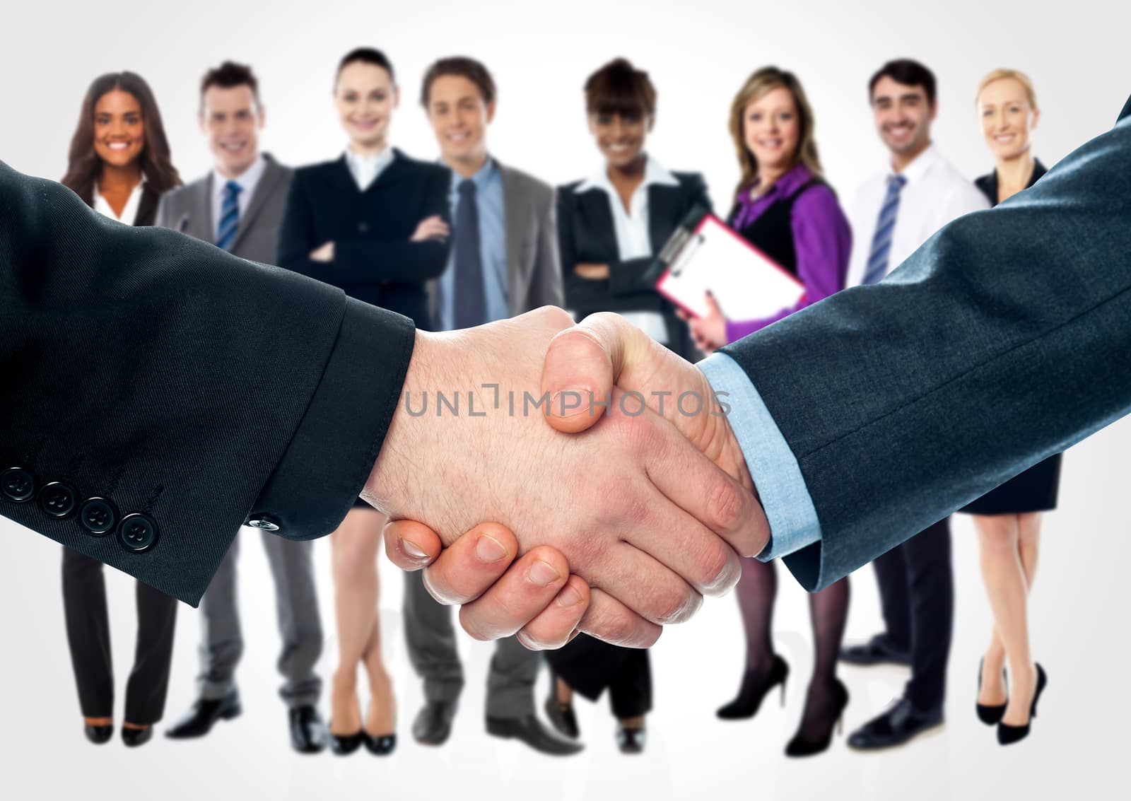 Business people shaking hands by stockyimages