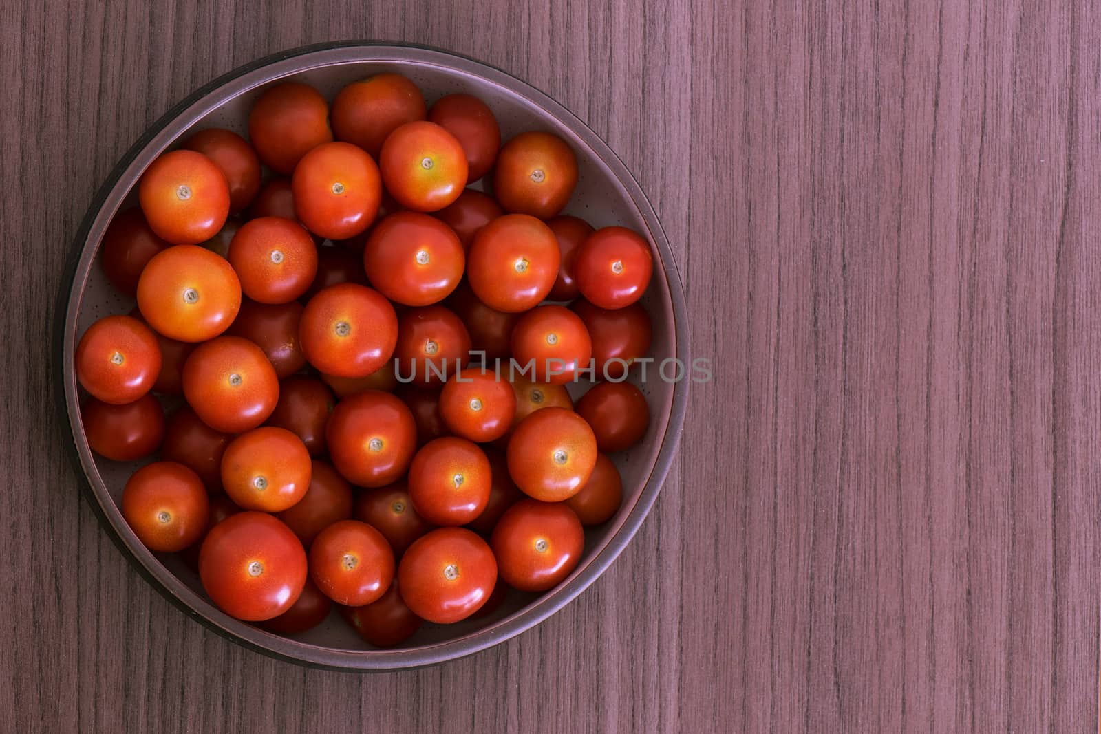 Bowl full of fresh red cherry tomatoes