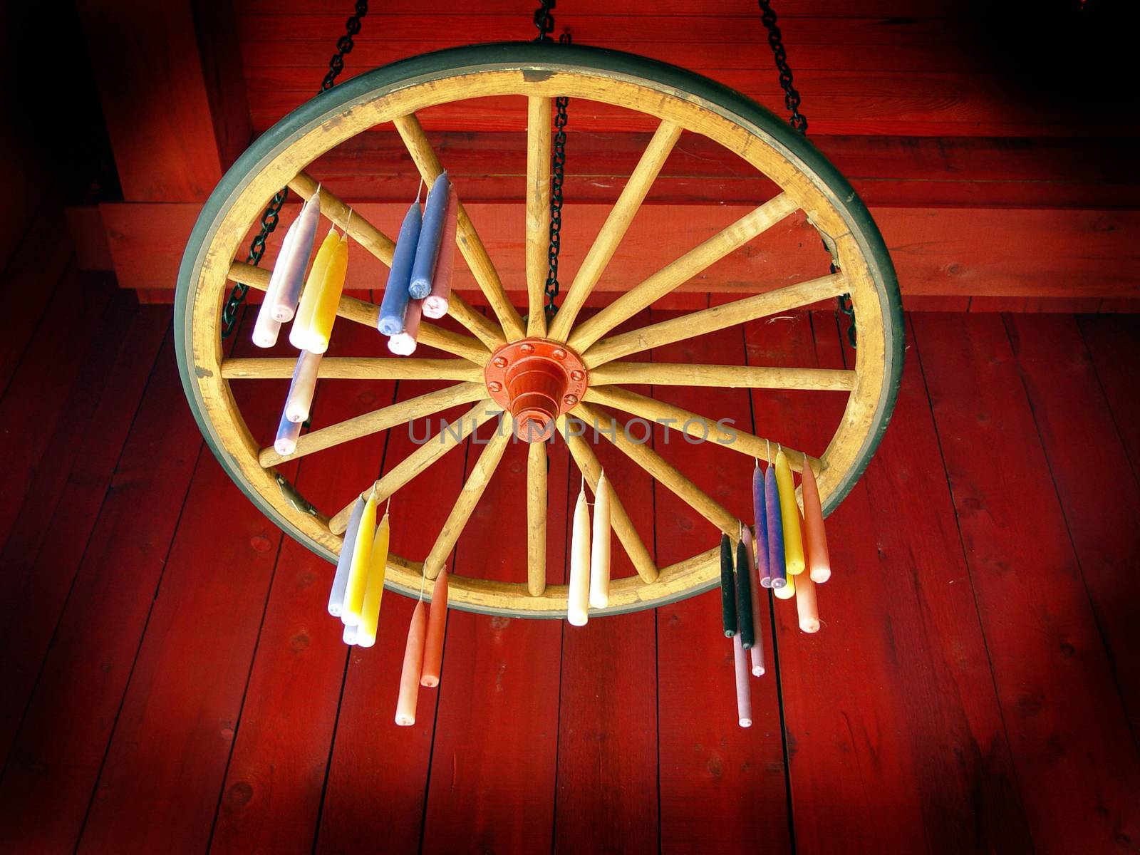 Candles hung to dry on wagon wheel
