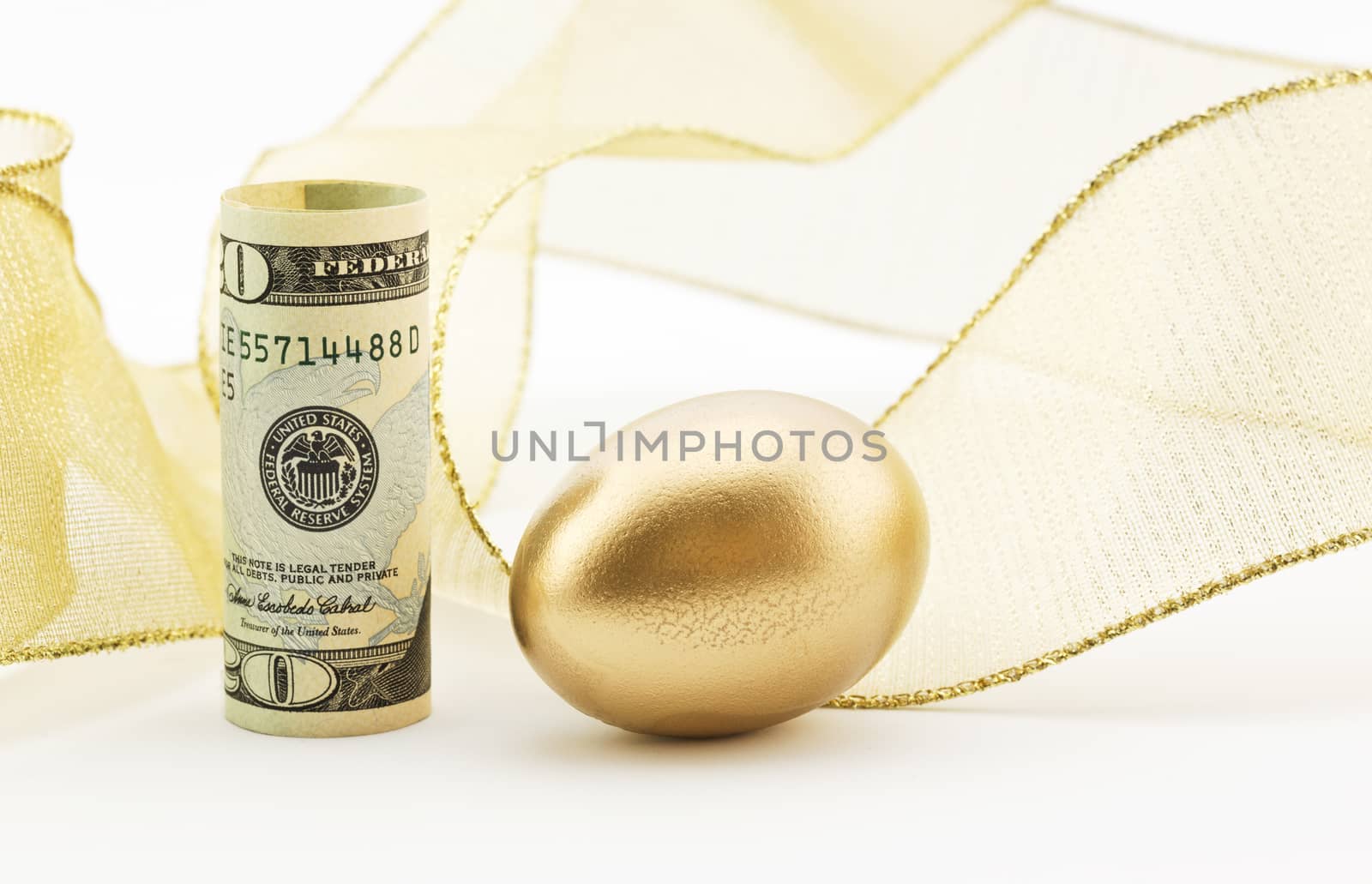 American dollar placed upright with gold nest egg and background of festive gold ribbon depicts successful outcome to investments