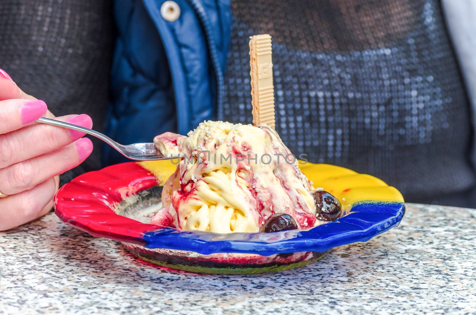 Woman in ice cream. Ice cream with waffle on a plate.