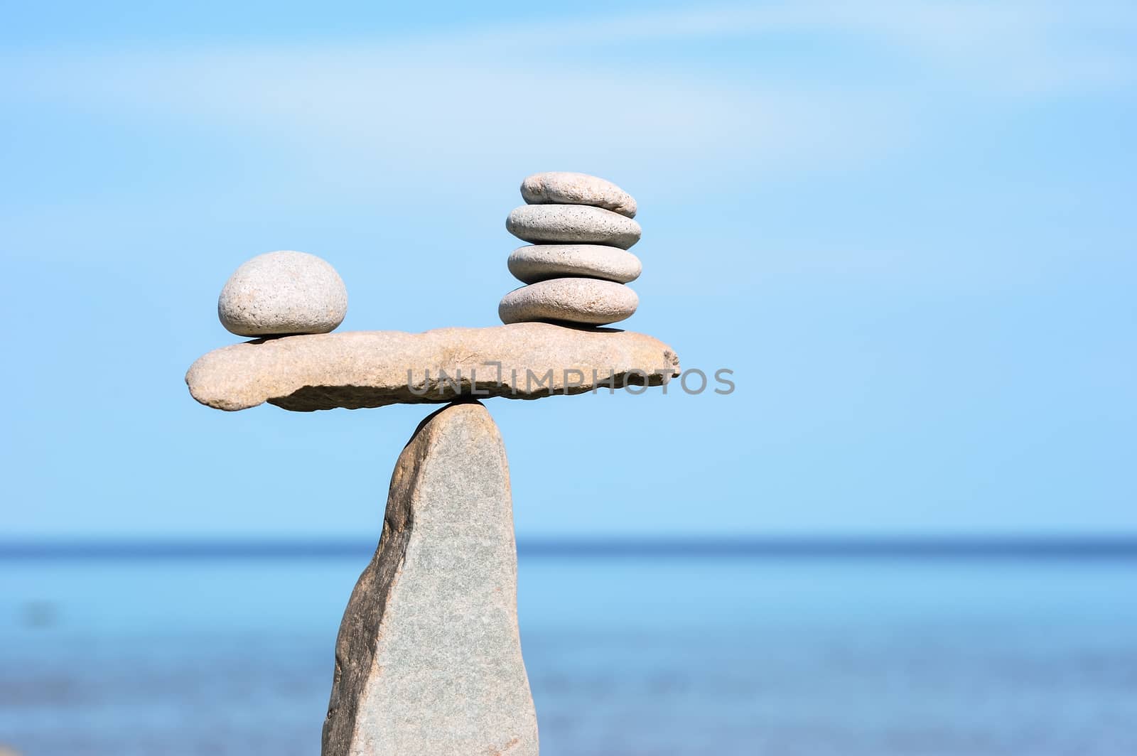 Balance of pebbles on the top of triangle stone