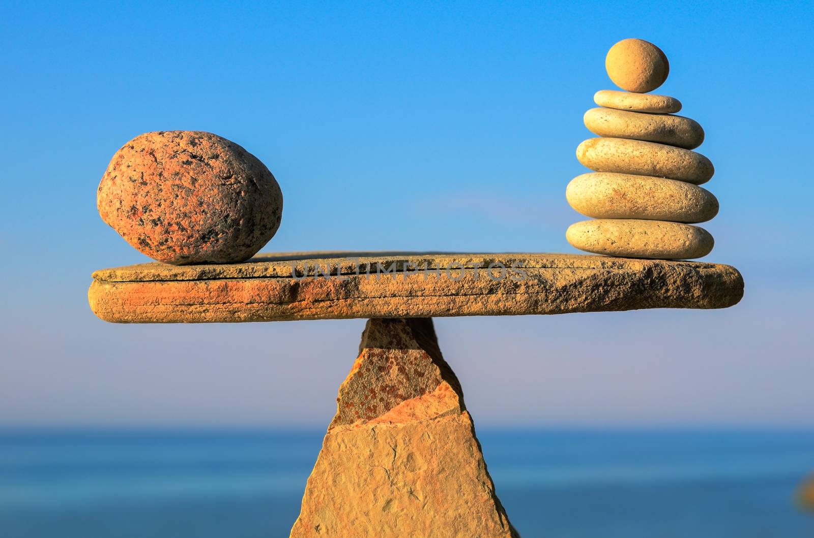 Balance of pebbles on the top of triangle stone