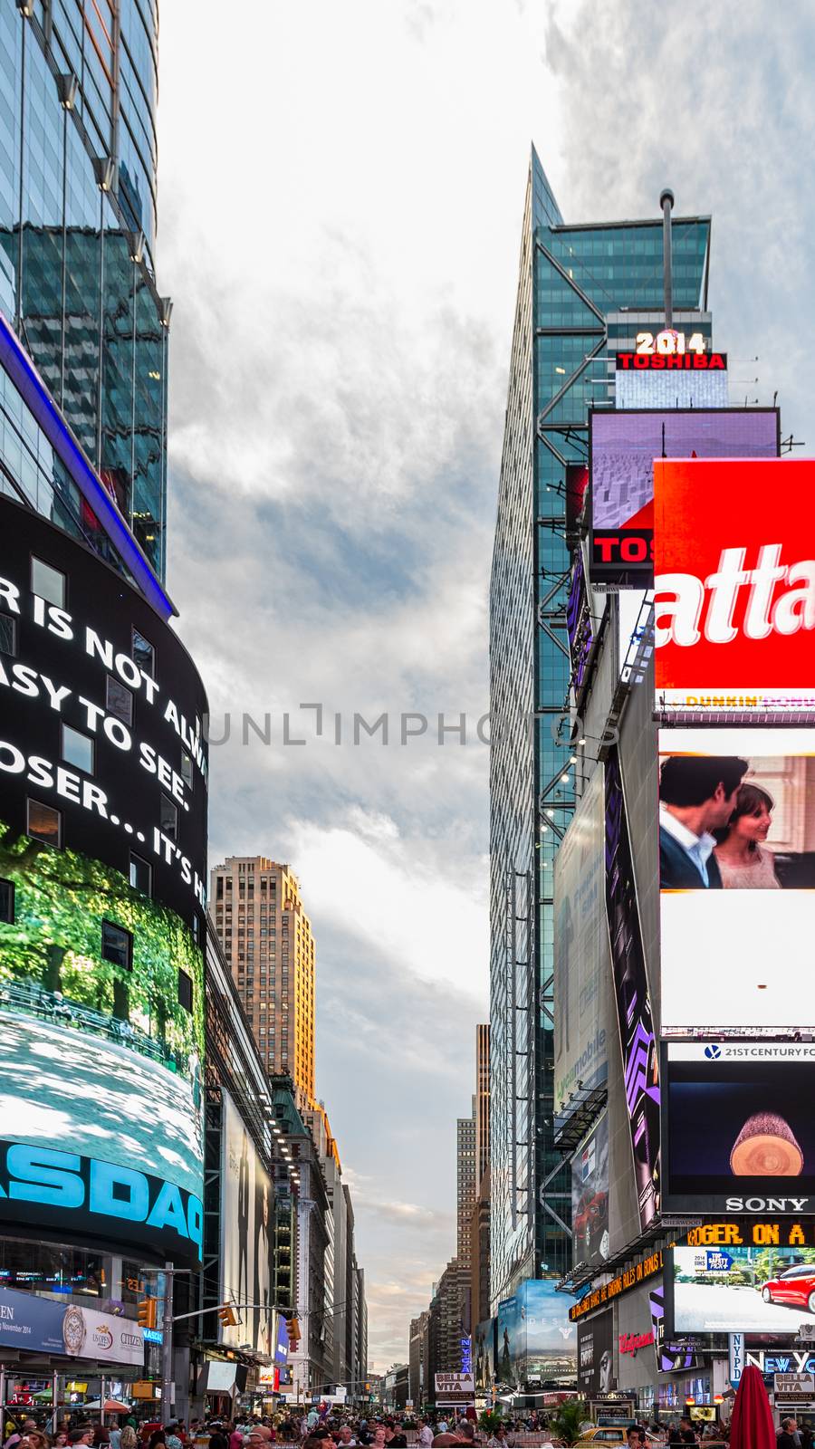 New York - Sept 2014: The glamorous streets of Times Square New York with thousands of tourists and residents are lit with giant screens displaying colorful advertisements on Sept 7, 2014 in New York, USA.