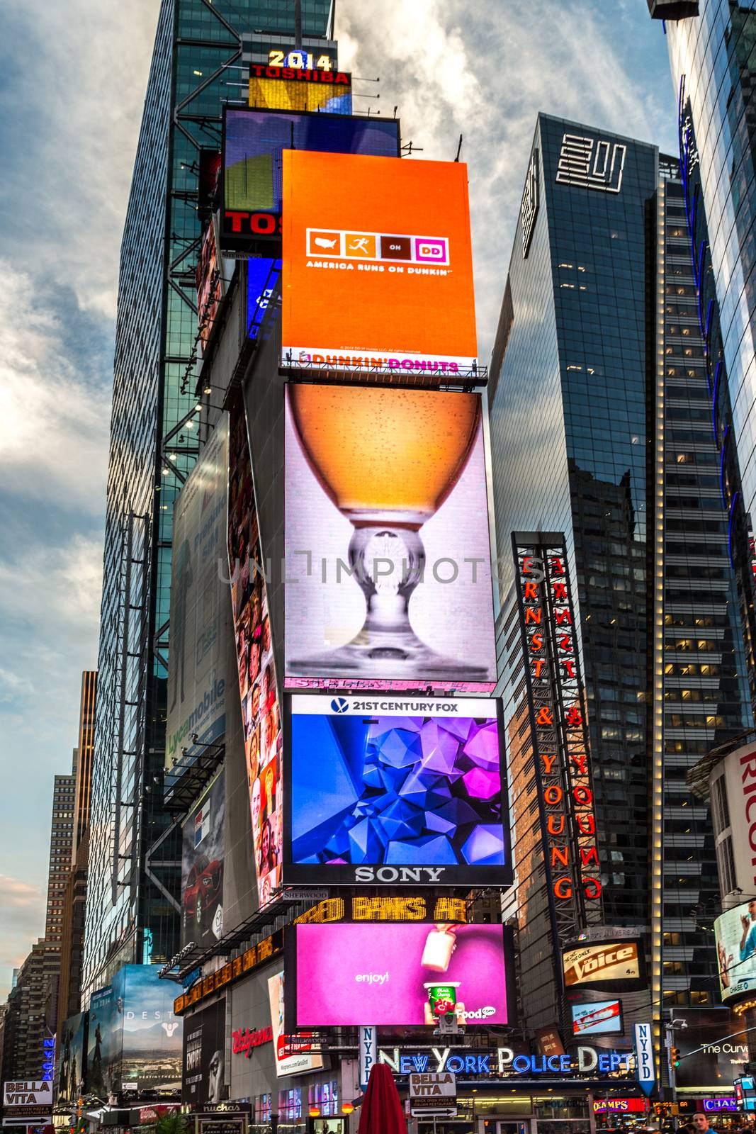 New York - Sept 2014: The glamorous streets of Times Square New York with thousands of tourists and residents are lit with giant screens displaying colorful advertisements on Sept 7, 2014 in New York, USA.