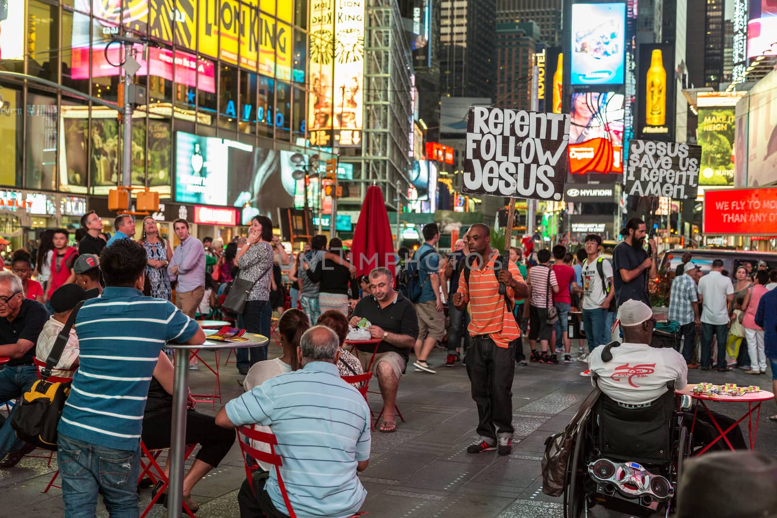 New York – Sept 2014: A man carrying a slogan which states “Repent! Follow Jesus!” for the thousands of tourists roaming the streets of Times Square on Sept 7, 2014 in New York, USA.