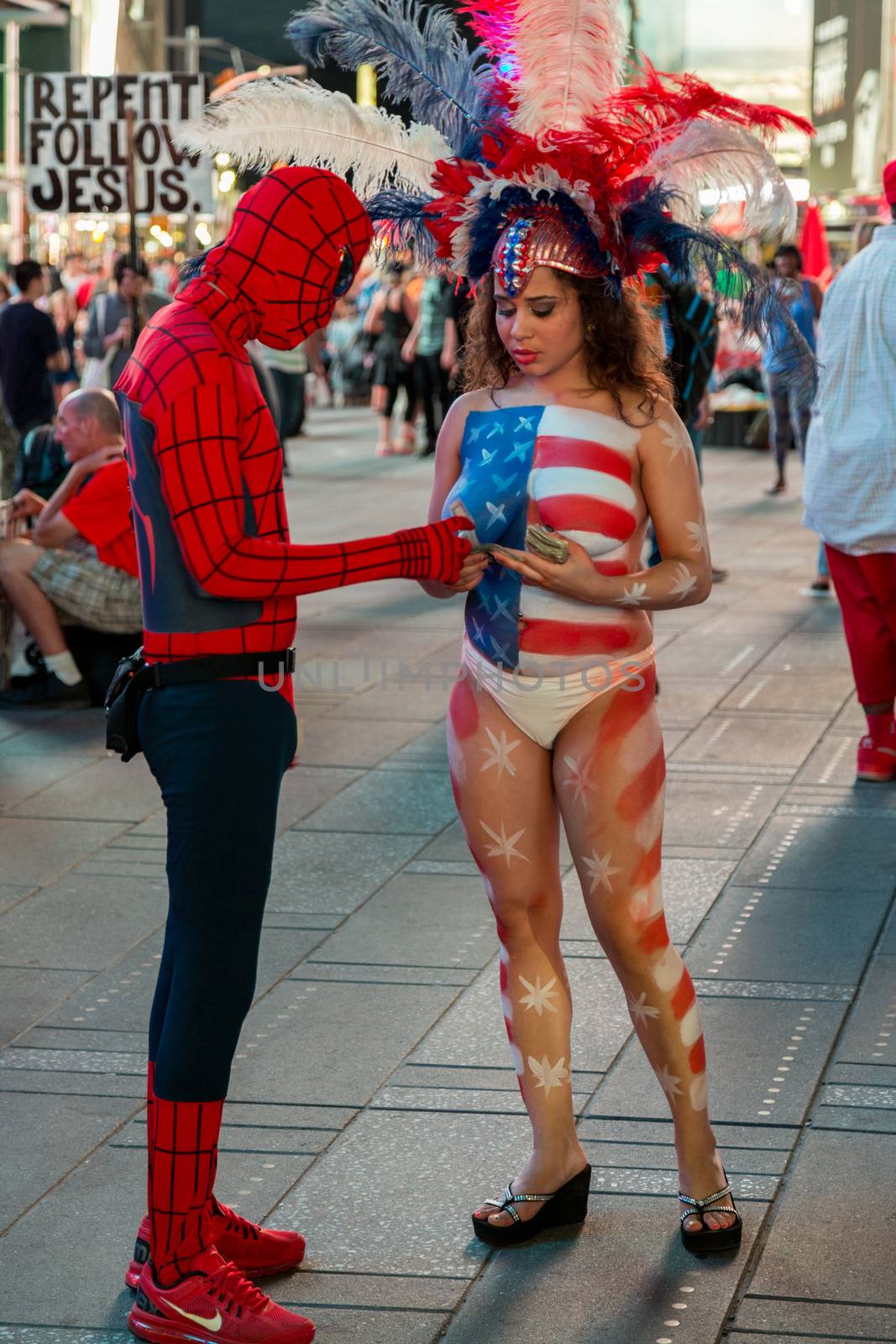 New York – Sept 2014: costumed superheroes and children's characters pose for photographs with Tourists on 42nd Street, Times Square on Sept 7, 2014 in New York, USA.