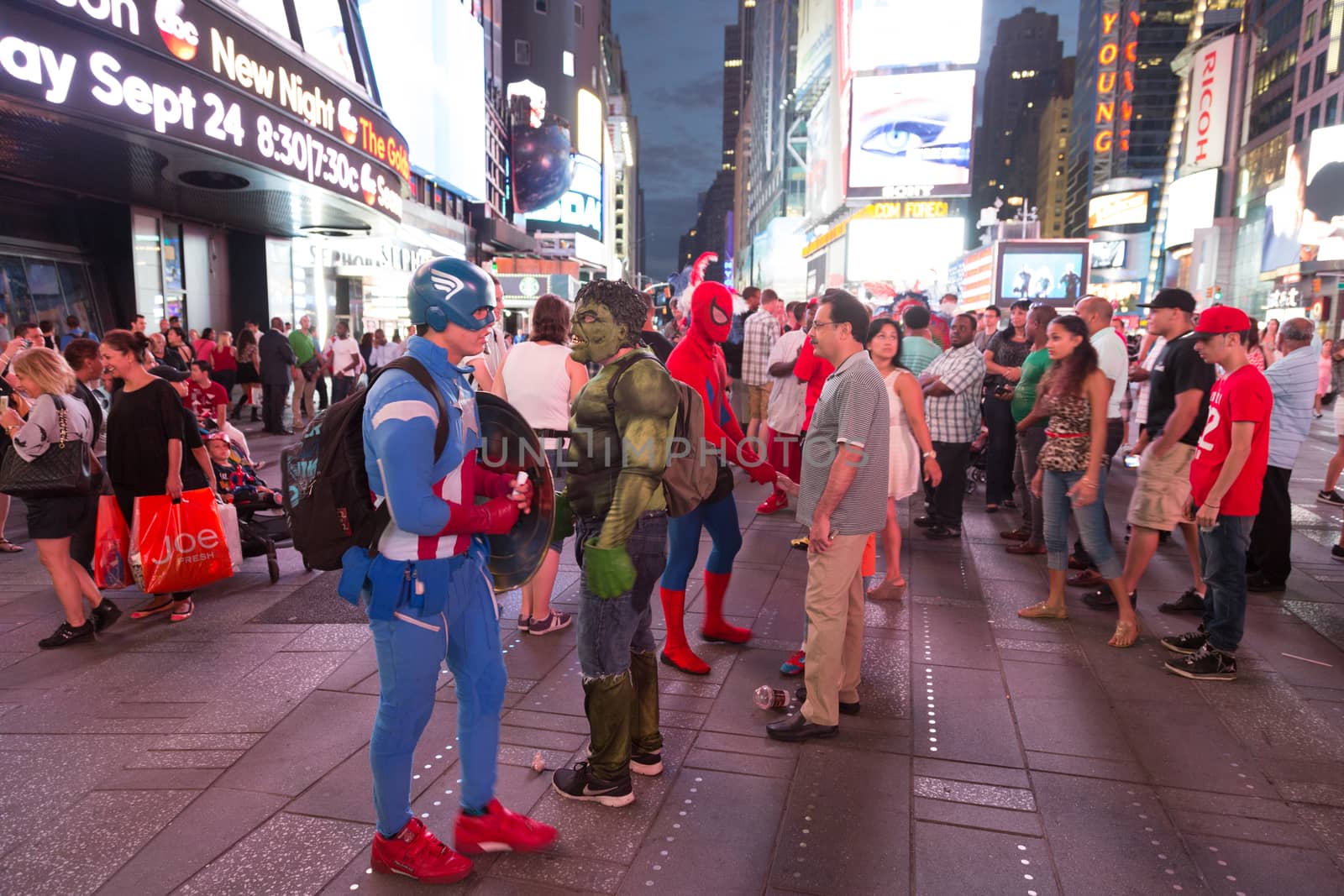 New York – Sept 2014: costumed superheroes and children's characters pose for photographs with Tourists on 42nd Street, Times Square on Sept 7, 2014 in New York, USA.