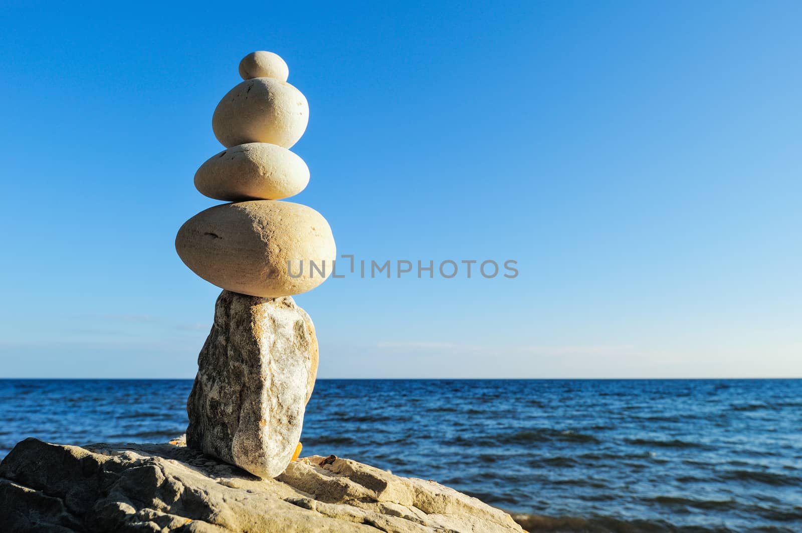 Balancing of white pebbles each other on the seacoast