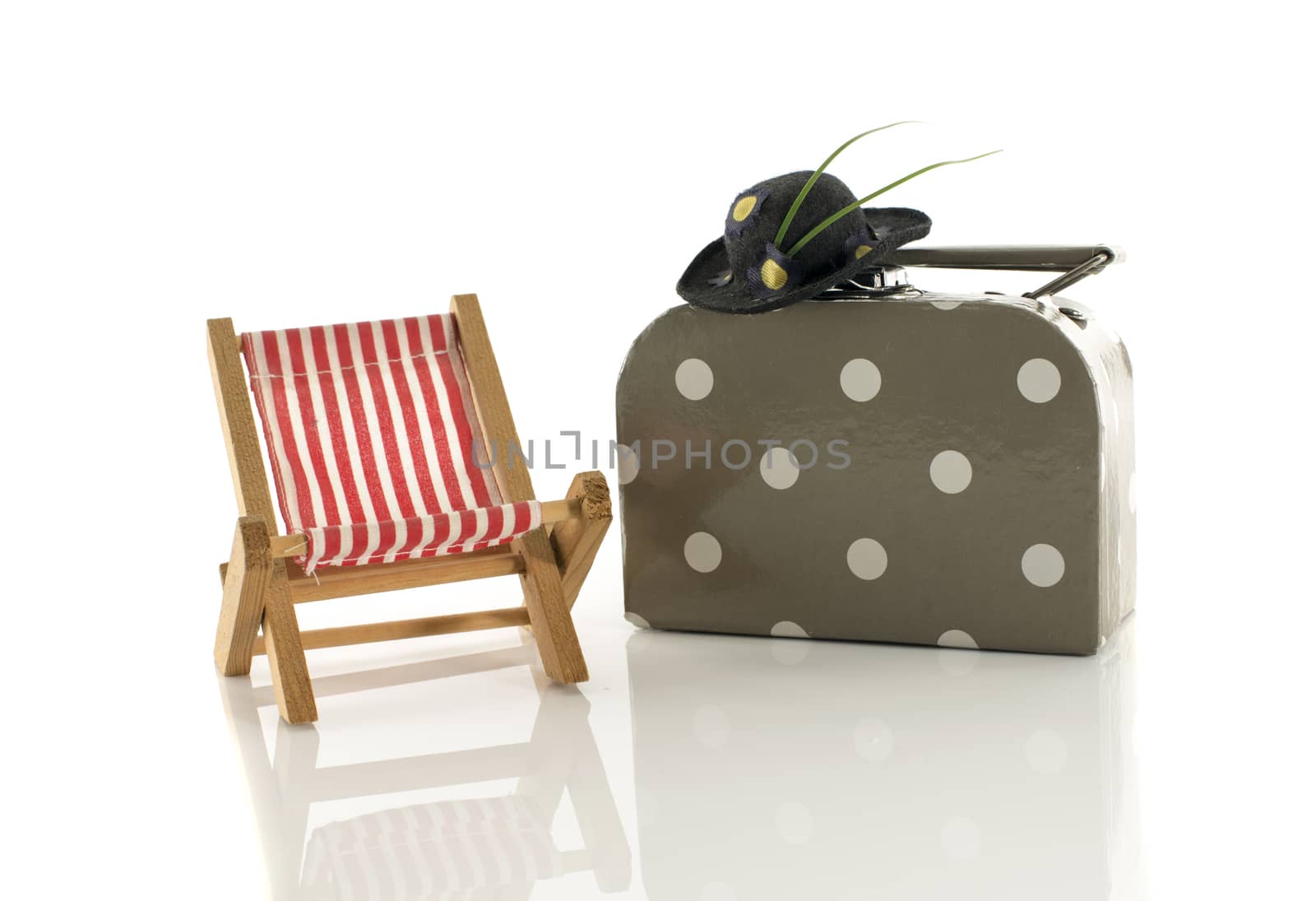 summer setting with suitcase chair and hat