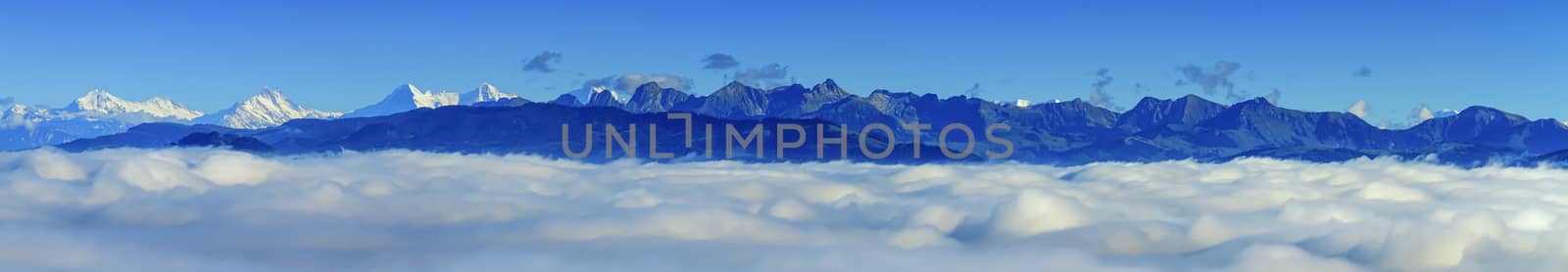 Aerial view on Alps mountains upon clouds, seen from upon Fribourg, Switzerland by Elenaphotos21