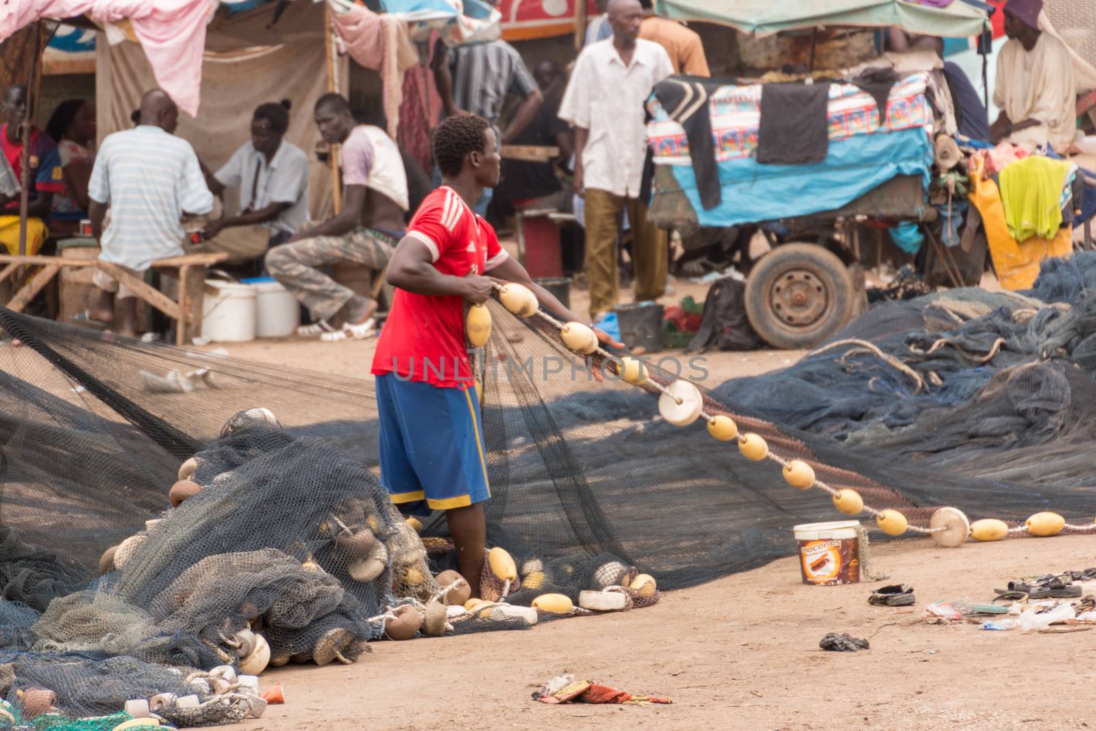 Mbour, Senegal - July, 2014: Fishermen set up their nets to go back to the see at the local fish market in Mbour on July 9, 2014 in Mbour, Senegal.