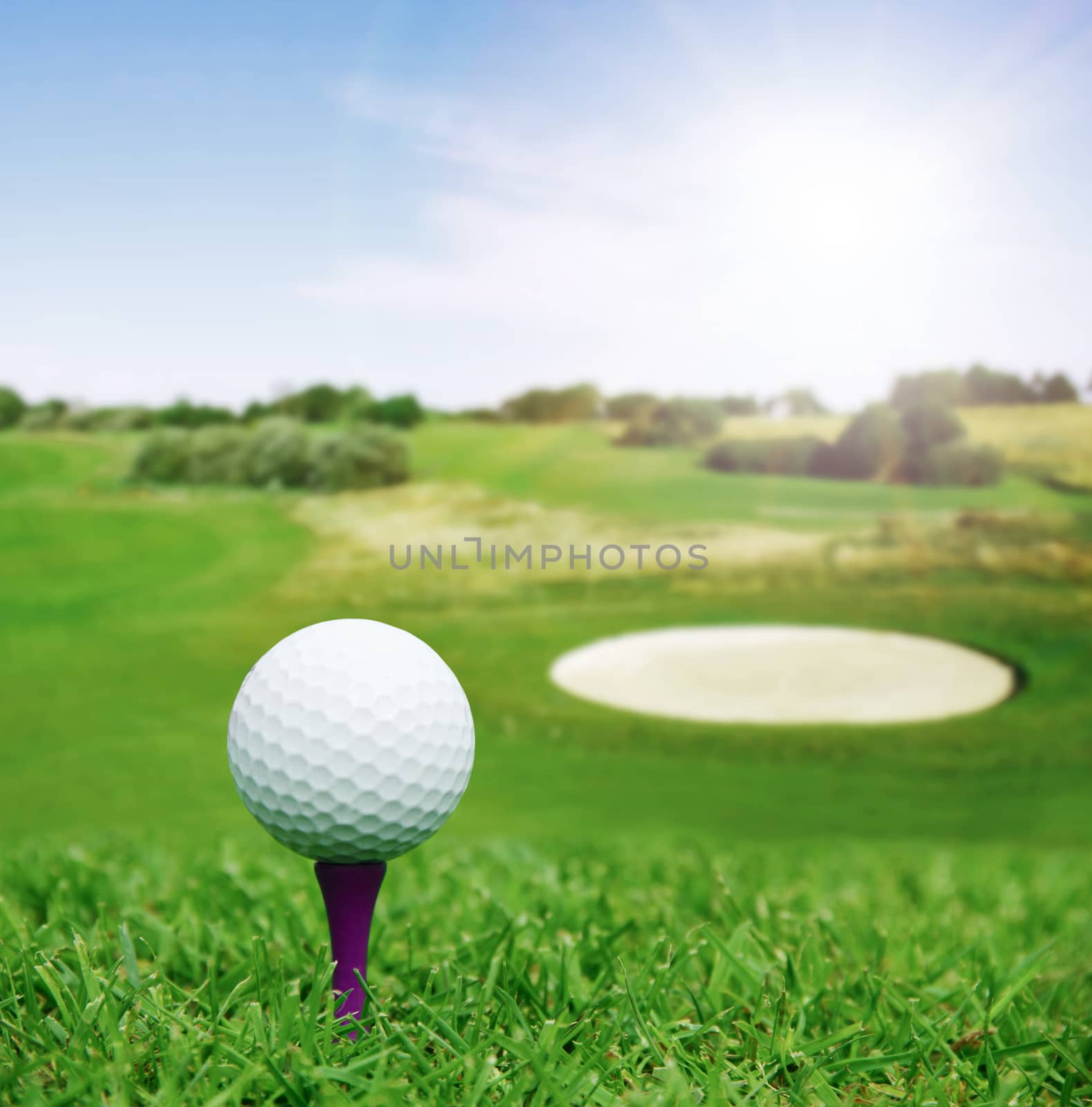 Golf ball on course with beautiful blurry landscape on background