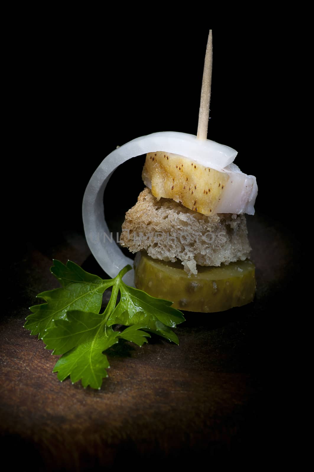 Canape with salted lard, onion, pickled cucumber, rye bread and parsley