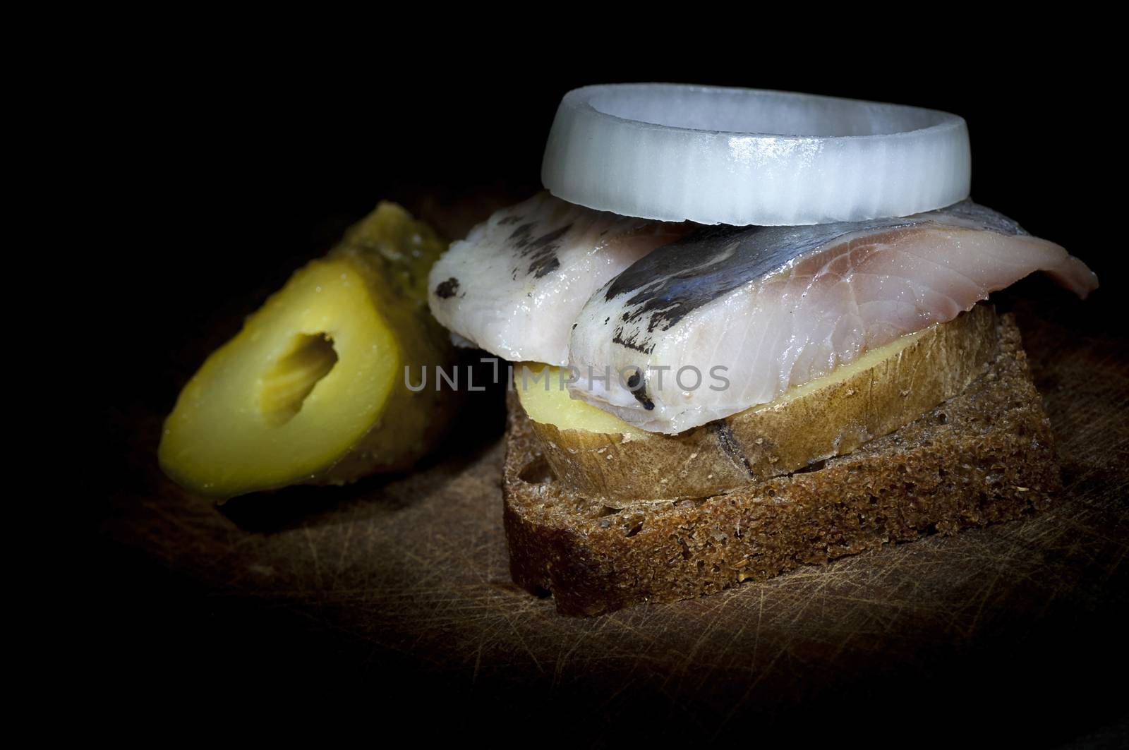 Sandwich made of herring on boiled jacket potato and rye bread
