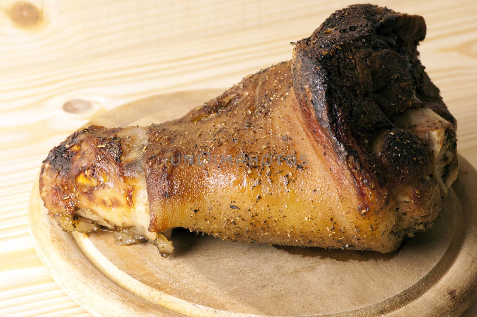 Roasted pork leg served on cutting board