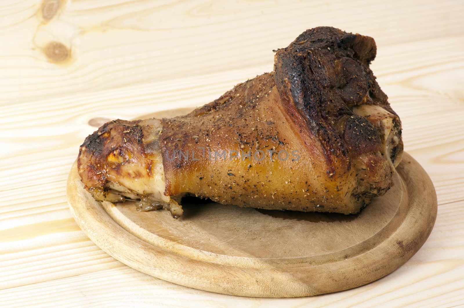 Roasted pork leg served on cutting board