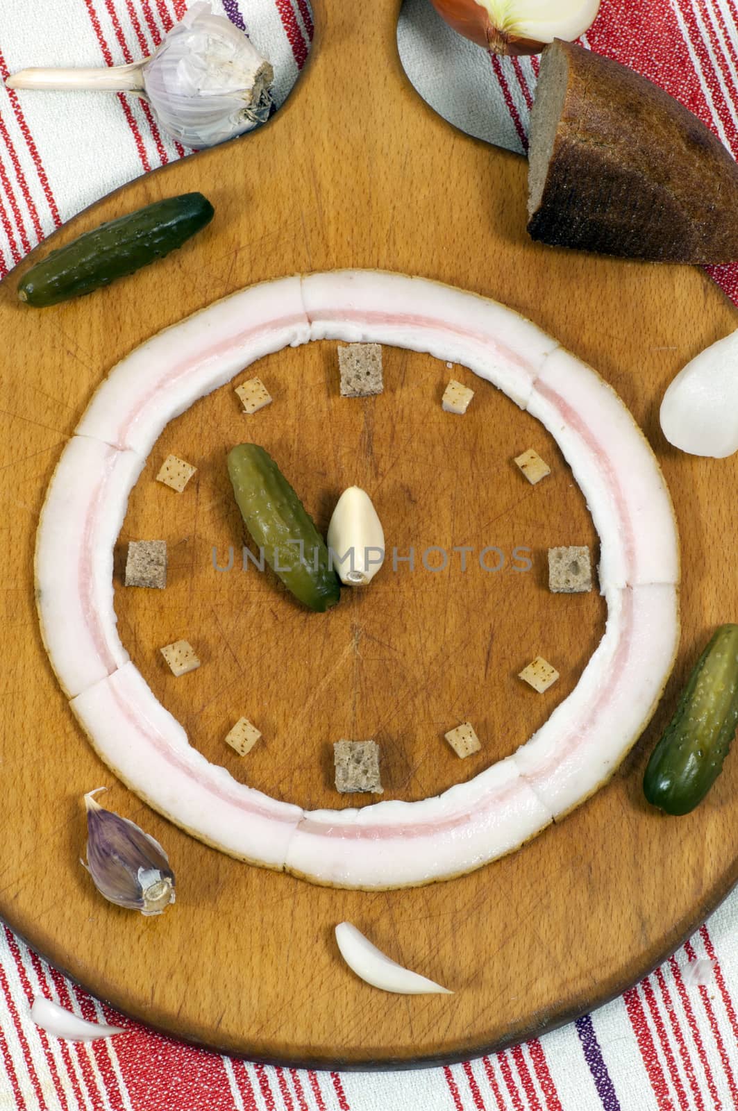 Clock made of salted lard, pickled cucumber and garlic