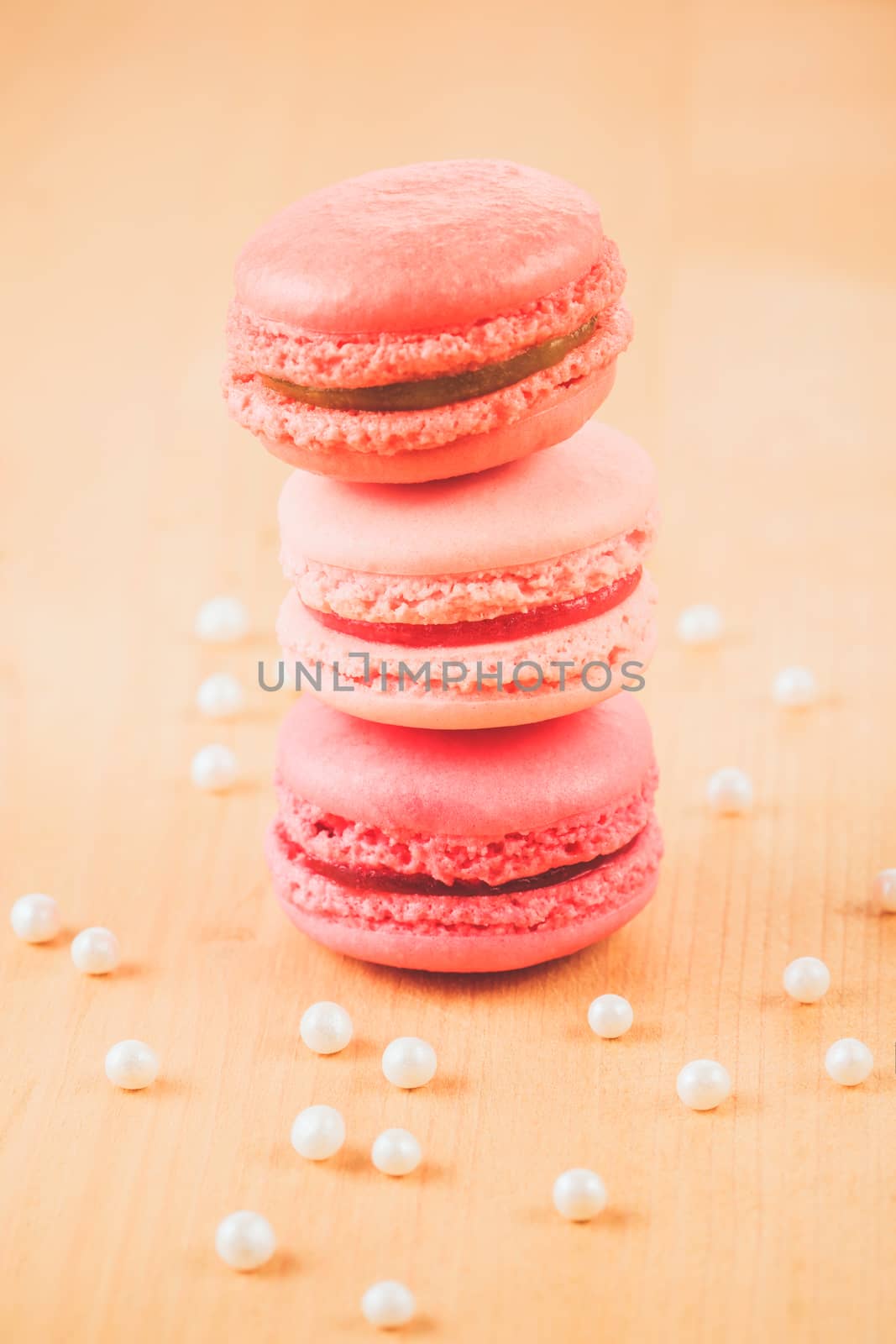 pile of strawberry, raspberry and rhubarb macaroons on wooden table