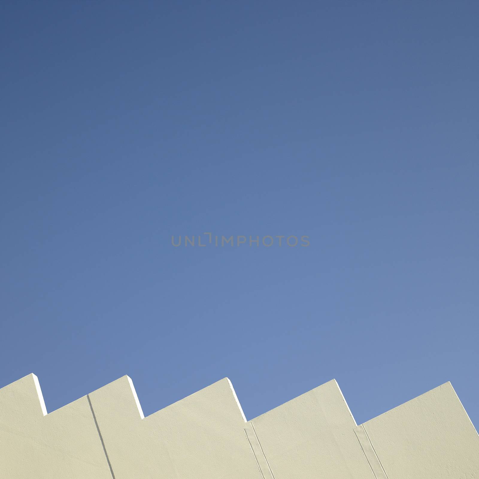 Jagged white wall and blue sky
