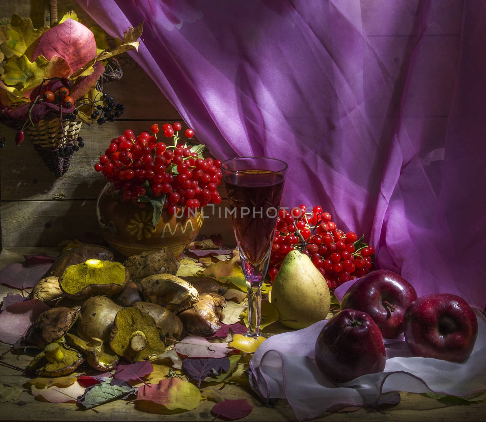 autumn still life with apple, pear, cranberry, mushroom, fallen leaves and glass of wine