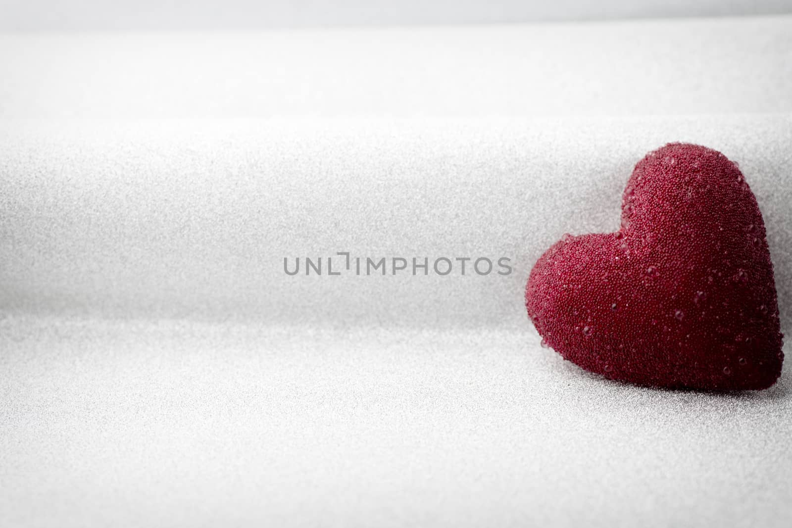 Red heart on a silver background.