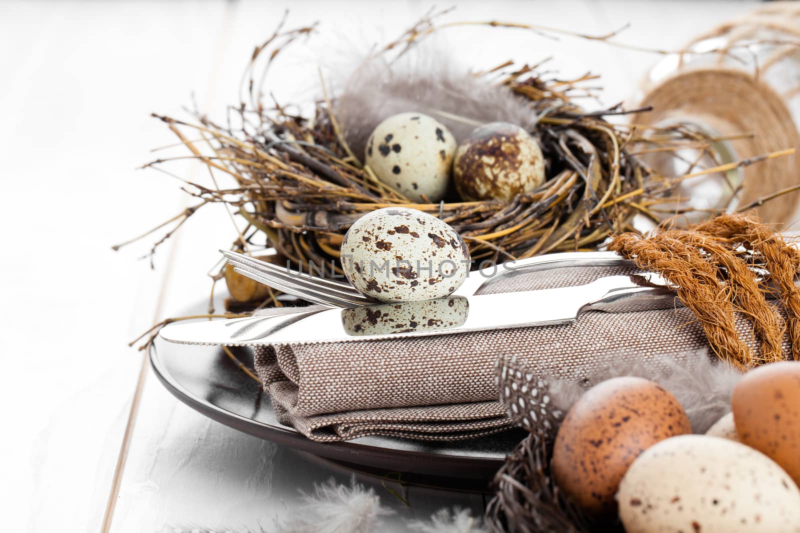 table decoration on white wooden background with quail eggs  by motorolka