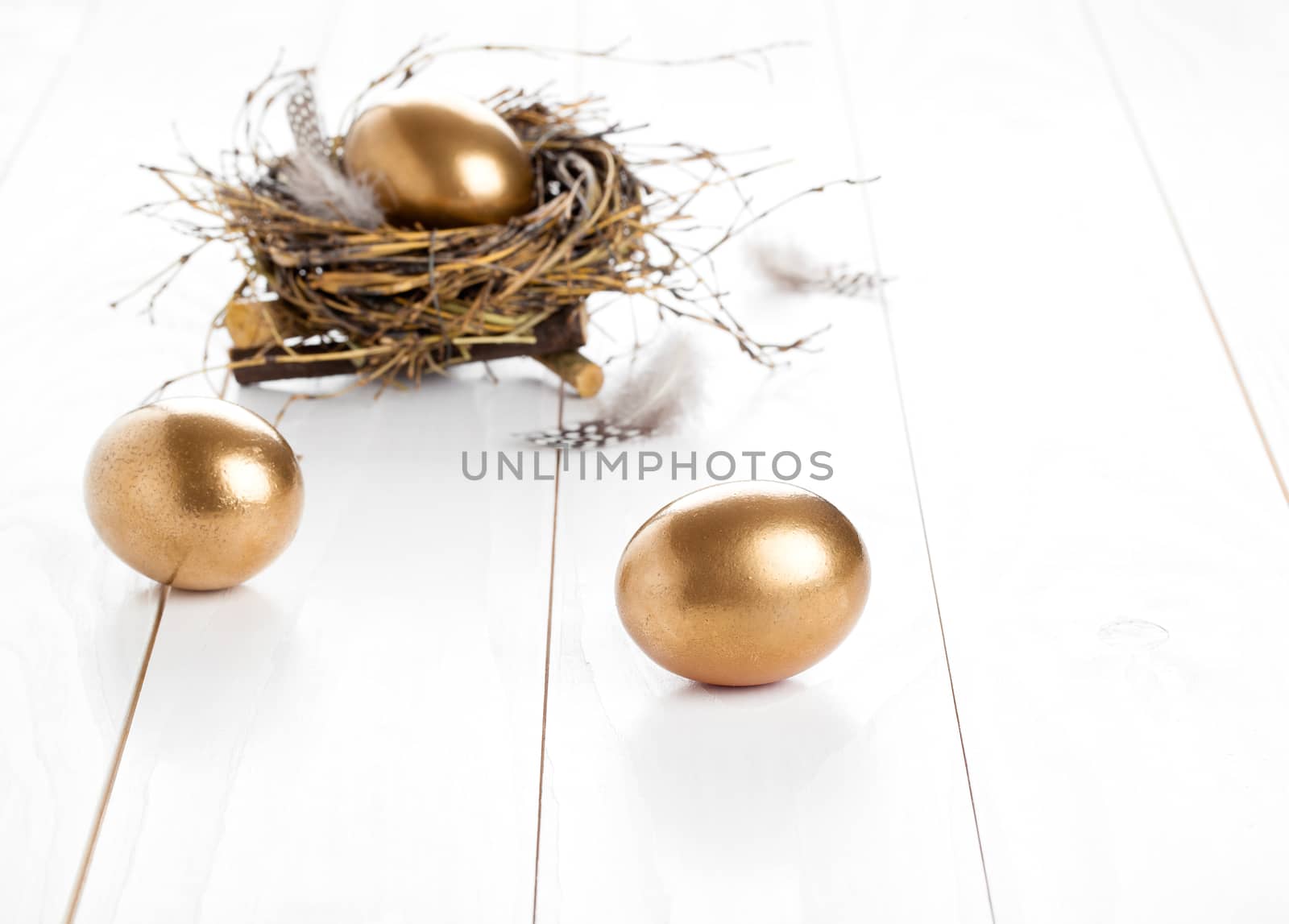 golden egg on white wooden background by motorolka