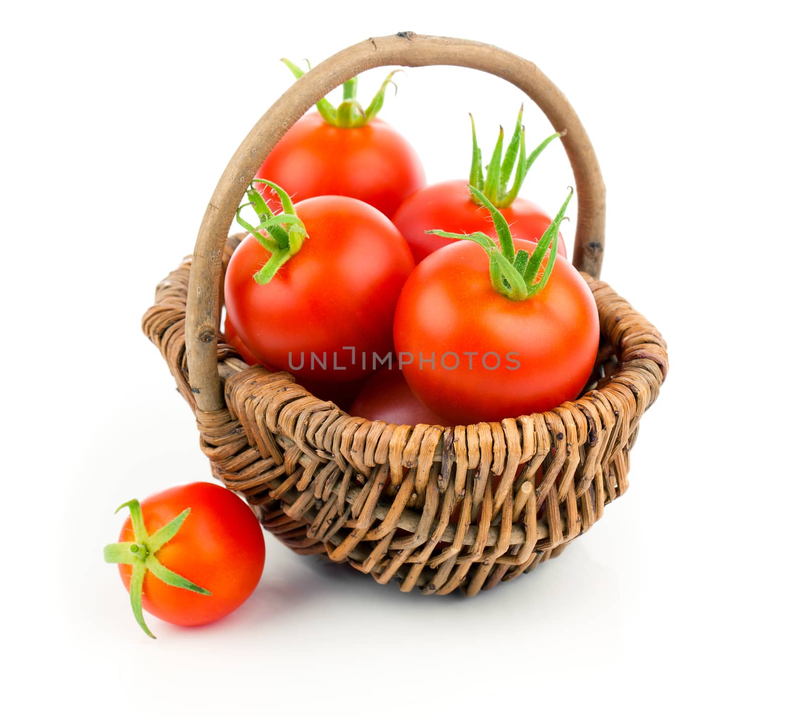 Cherry tomatoes in the wicker basket, isolated on white backgrou by motorolka