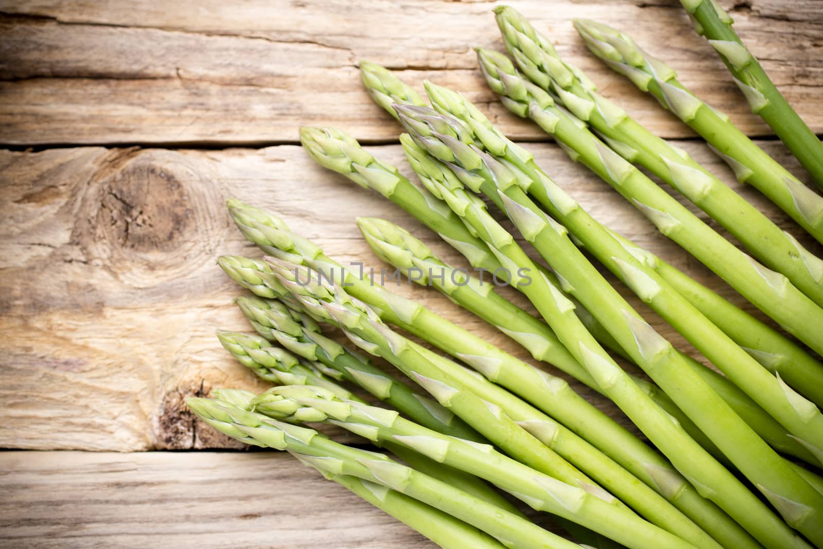 Asparagus on the wooden background.