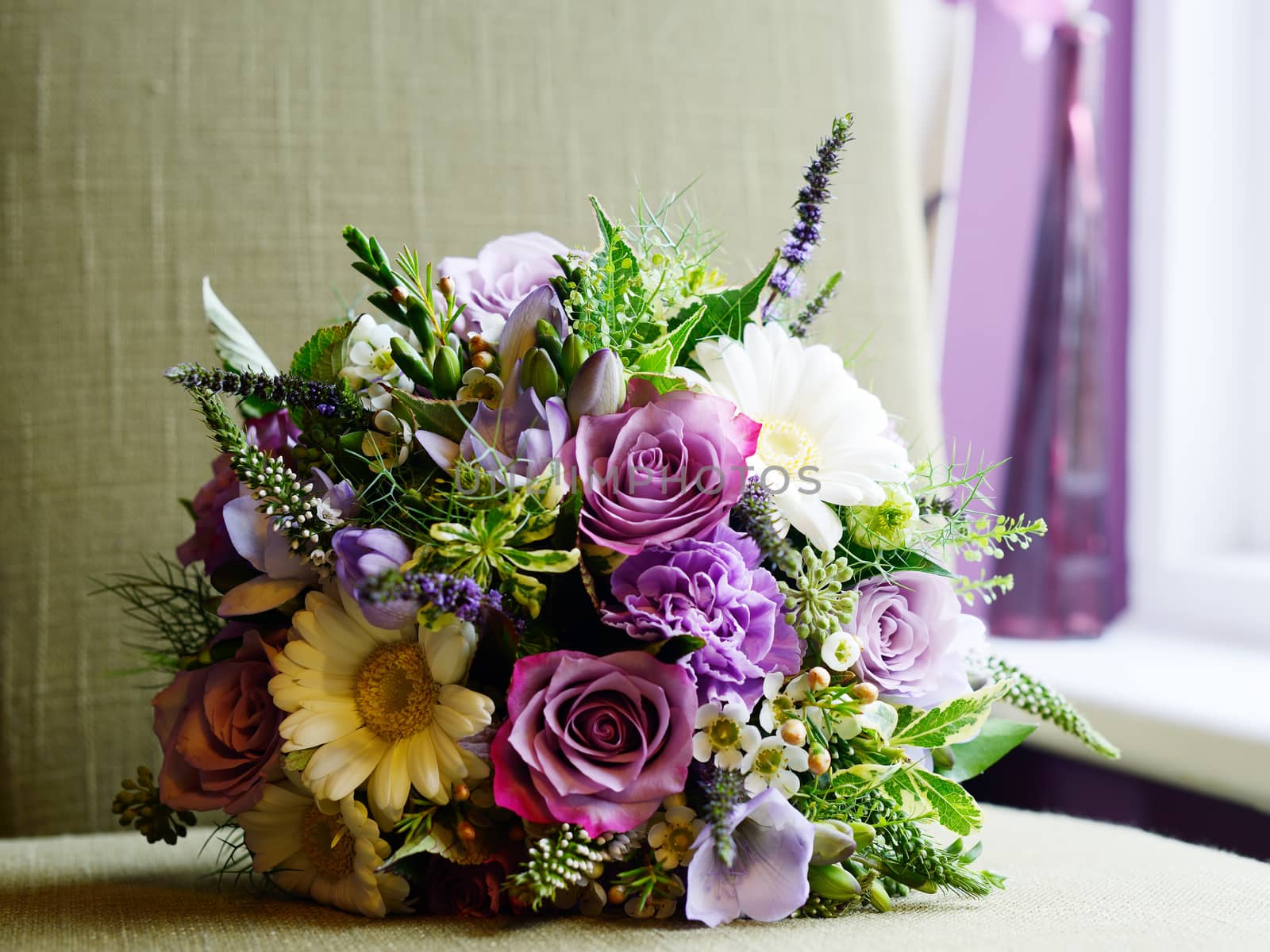 Brides bouquet with purple and white flowers on wedding day