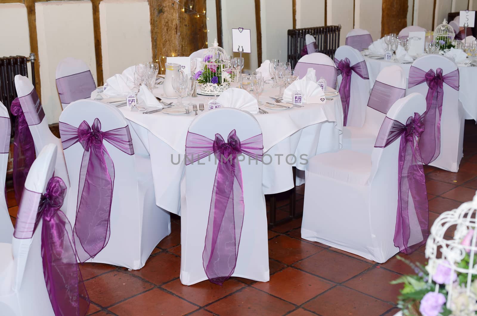 Wedding reception showing chair and table covers in white and purple