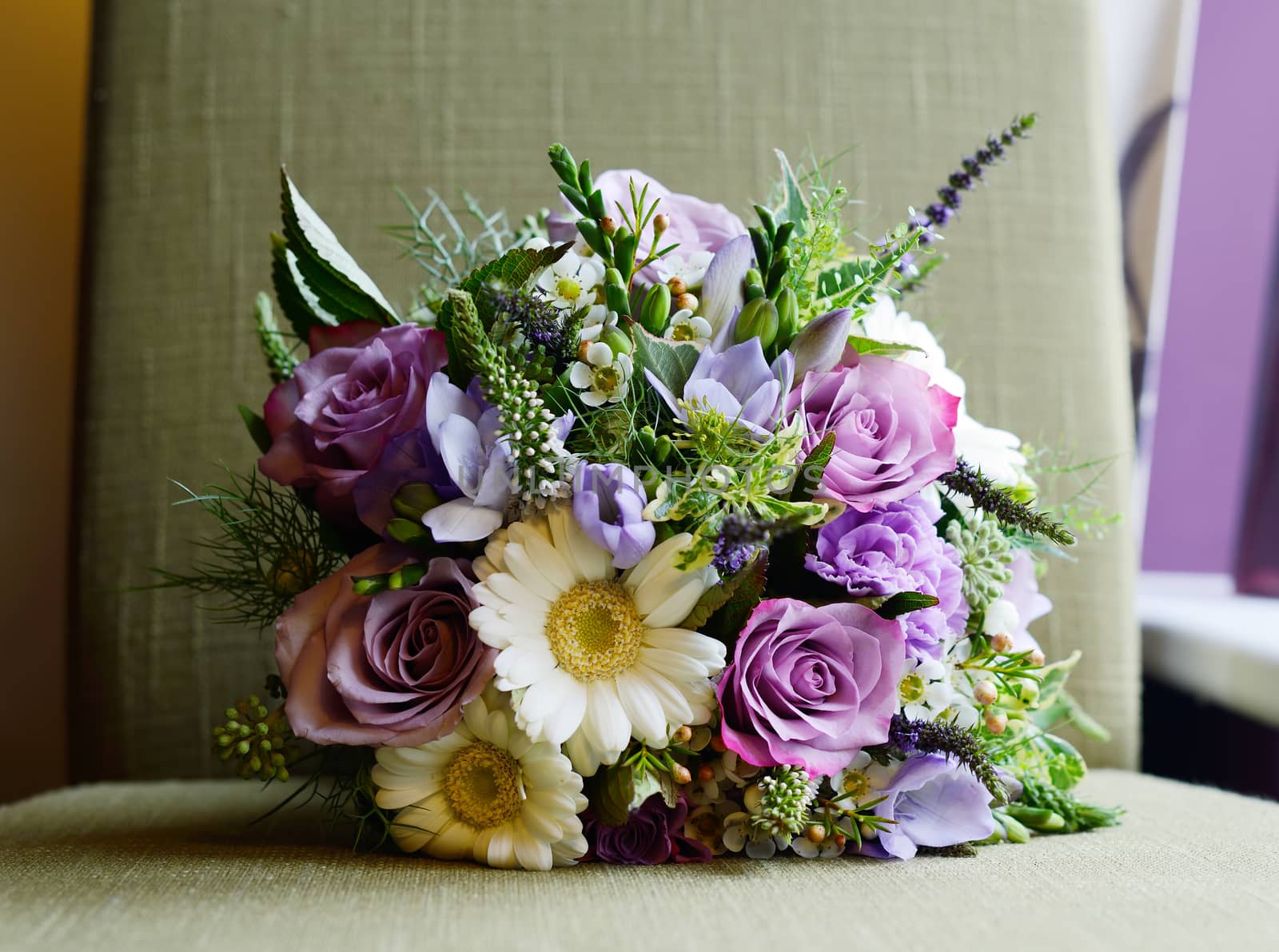 Brides purple bouquet of flowers on wedding day