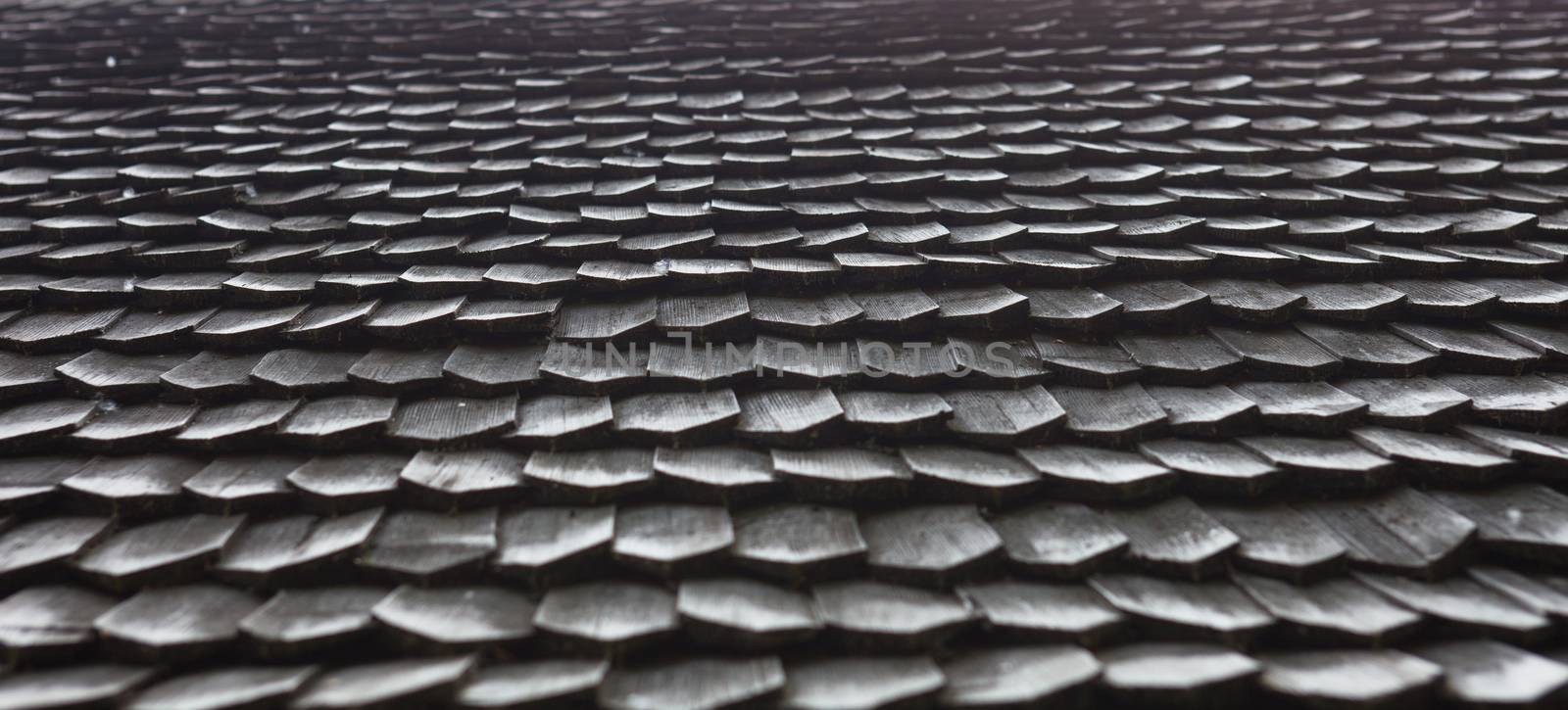 Old wooden shingle roof. Wooden surface texture.