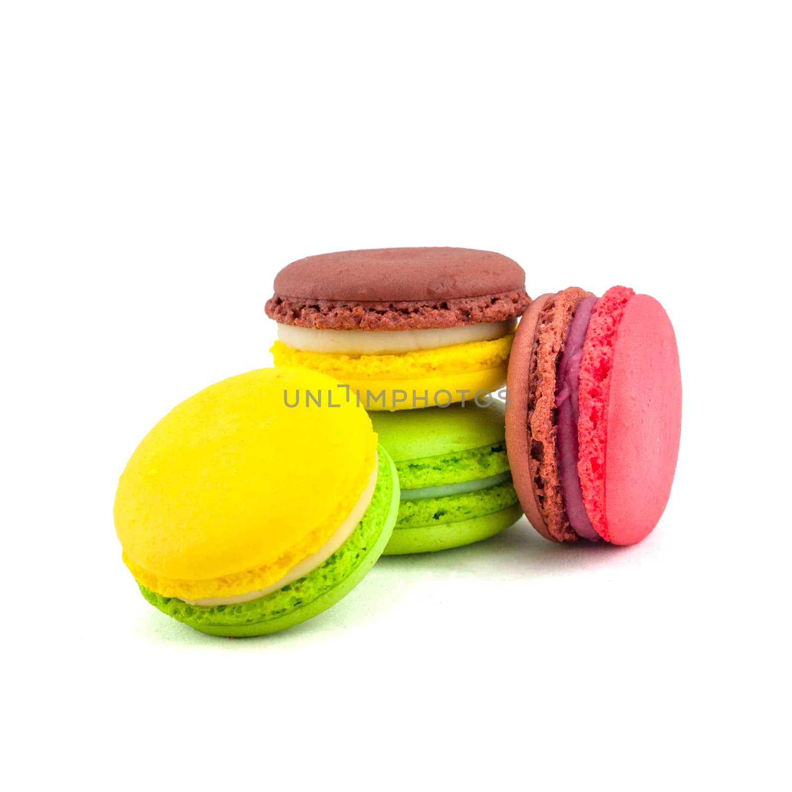 Sweet and colourful french macaroons isolated on white background .