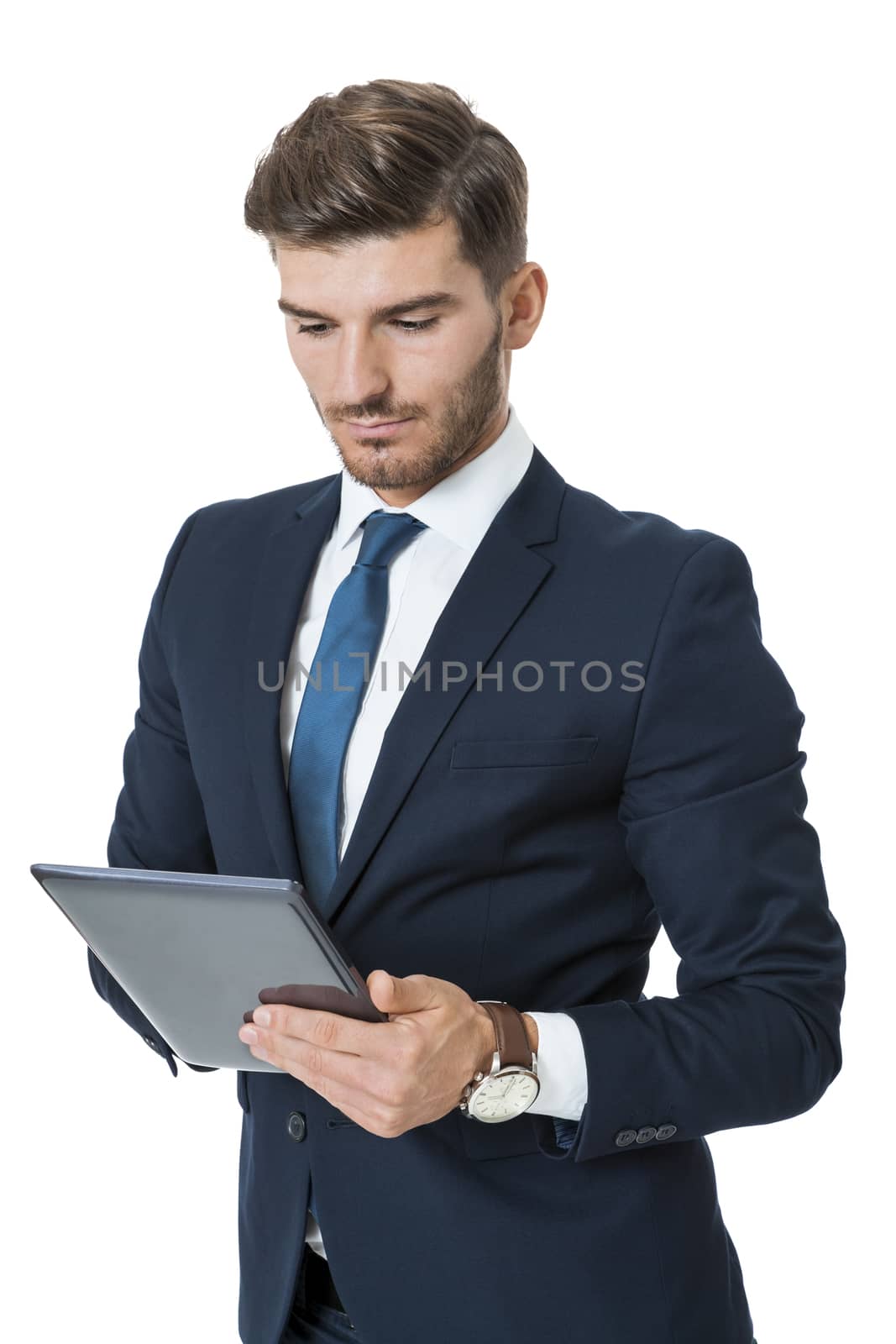 Businessman using a tablet computer navigating the touchscreen with his finger as he surfs the internet, close up view of his hands and the tablet, on white