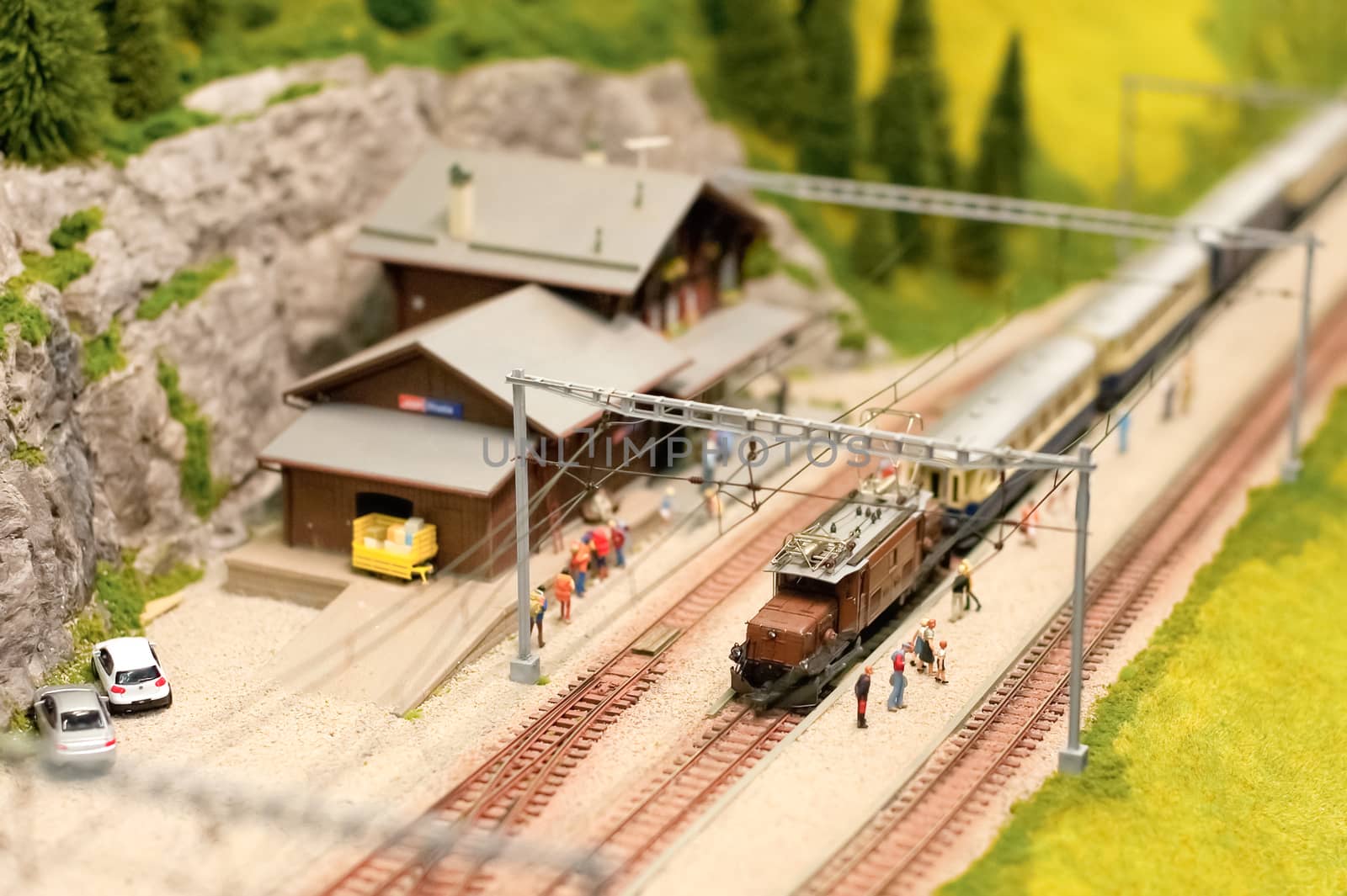 miniature alpine railroad model with overhead electric power lines