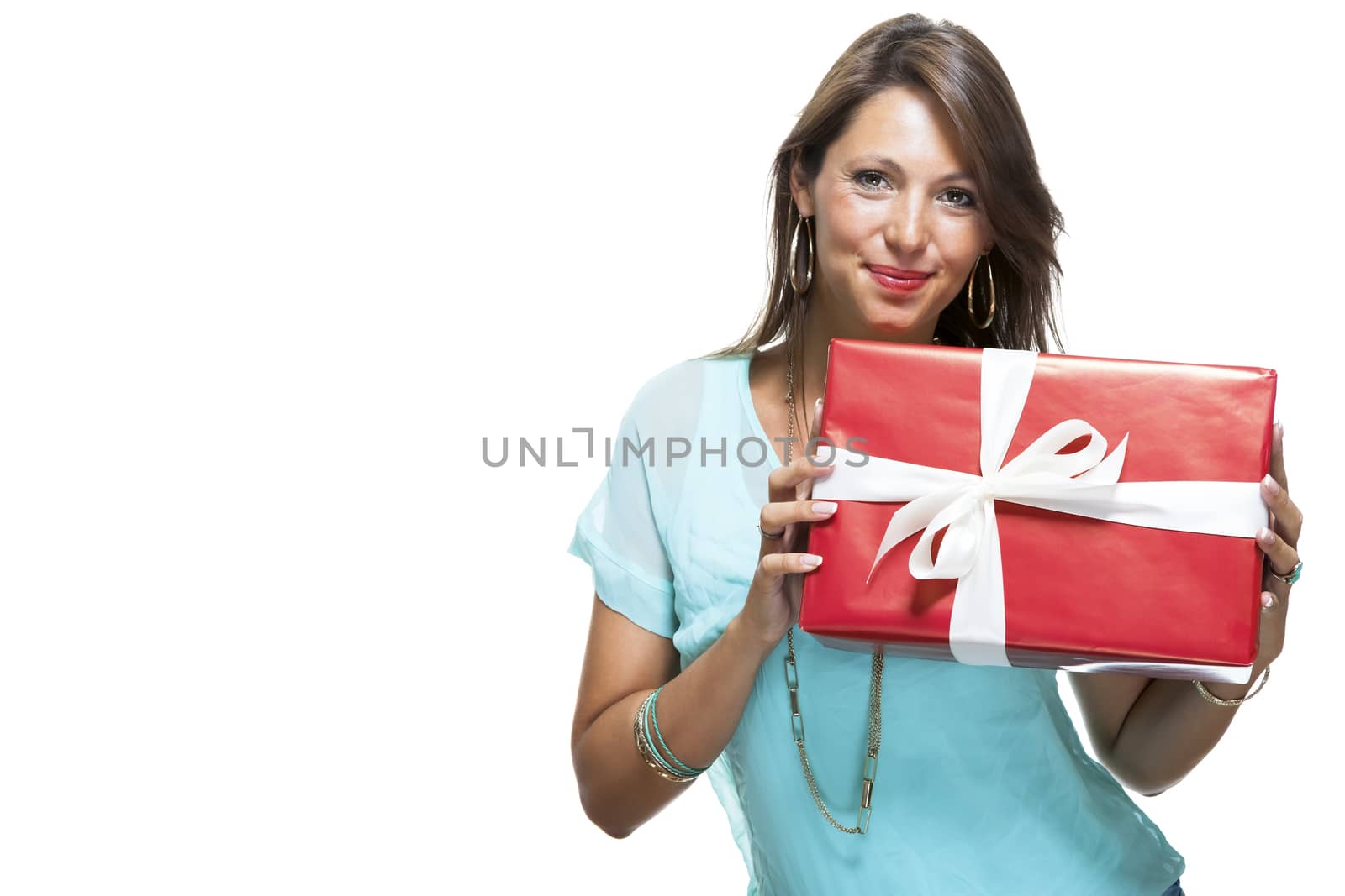 Close up Portrait of Happy Young Woman in Casual Clothing Holding a Red Big Gift Box with White Ribbon While Looking at the Camera. Isolated on White Background.