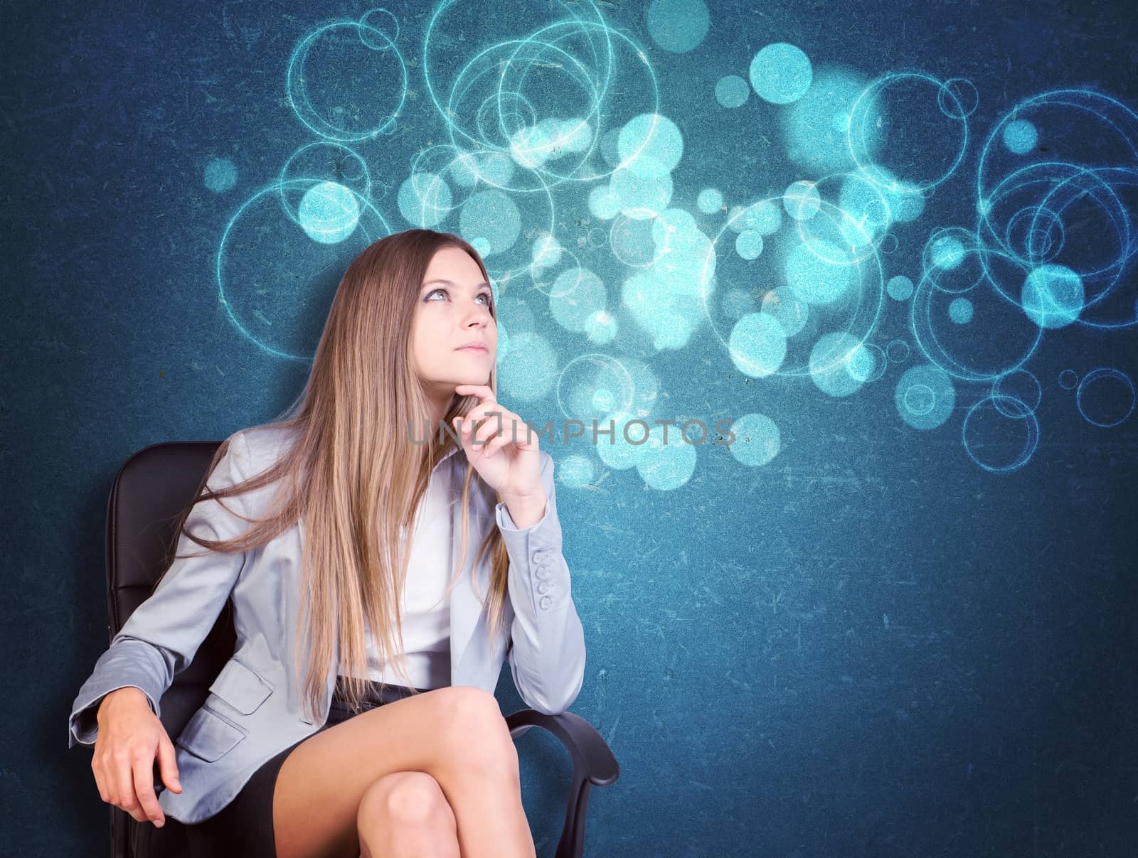 Woman in jacket and blouse sits on chair and looking up. Abstract background with circles