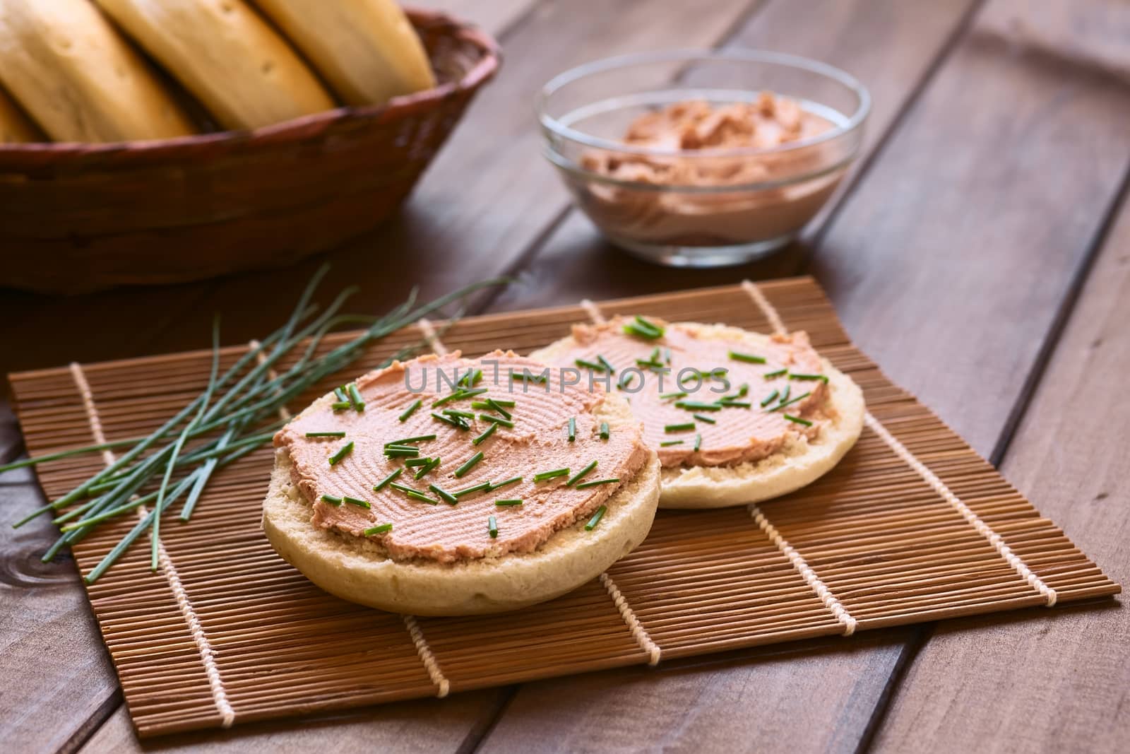 Liverwurst spread on bun with chives photographed with natural light (Selective Focus, Focus one third into the bun)