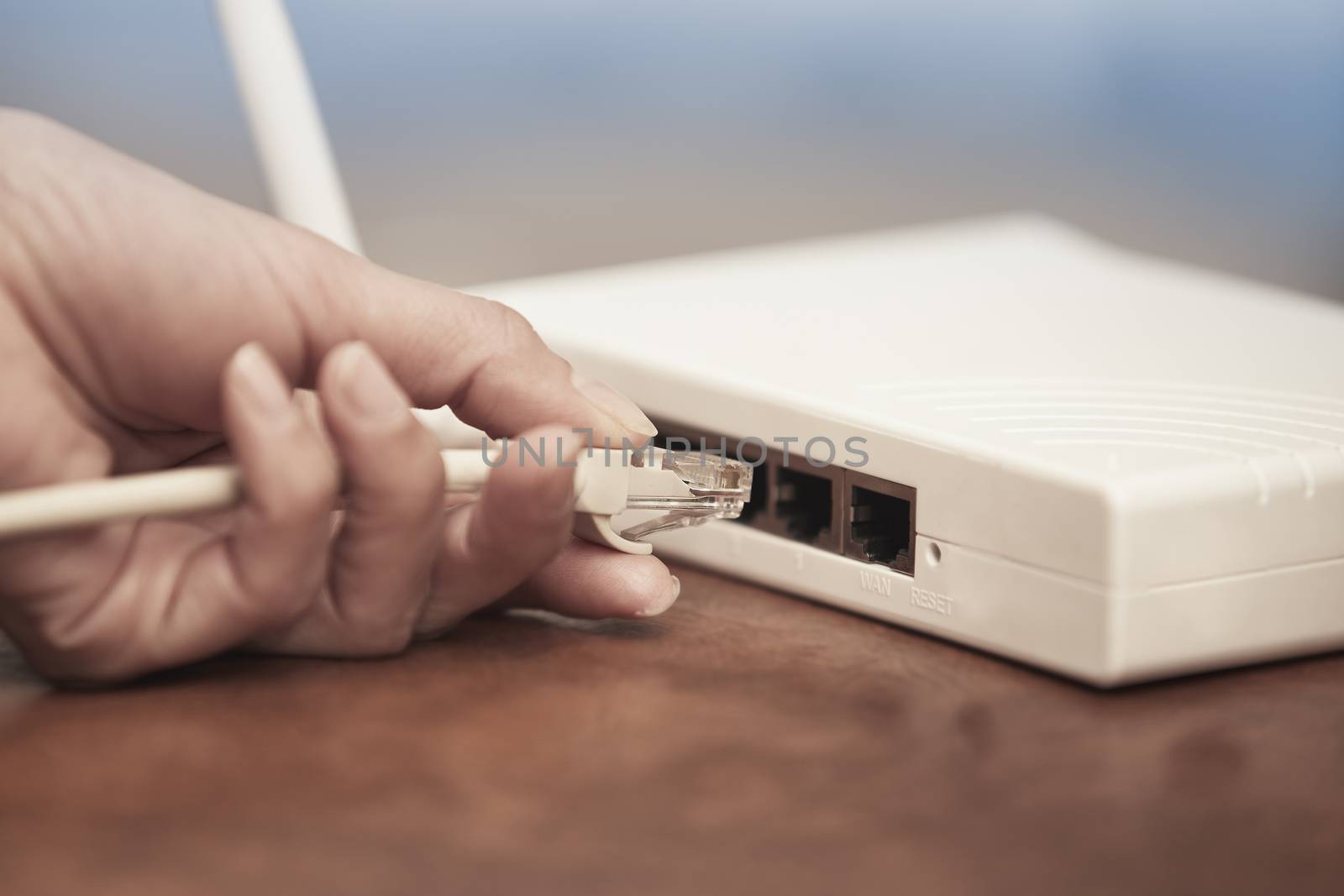 Human hand pluging patchcord to the wireless modem