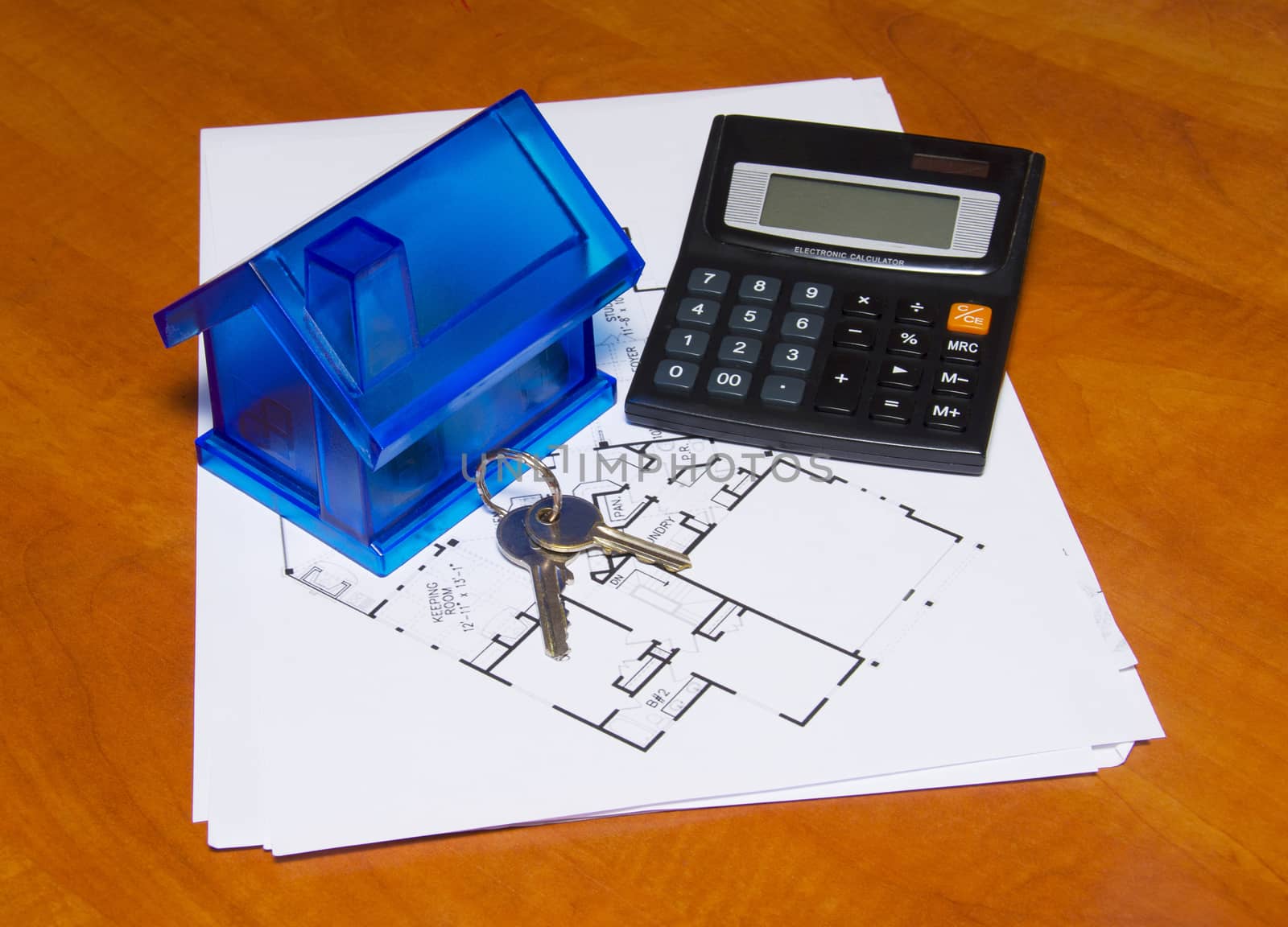 Toy house and calculator on table