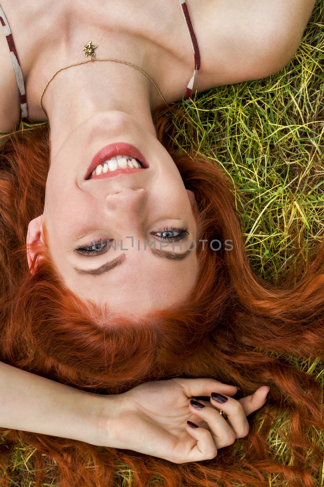 Close up Very Happy Young Woman Lying on Grassy Ground