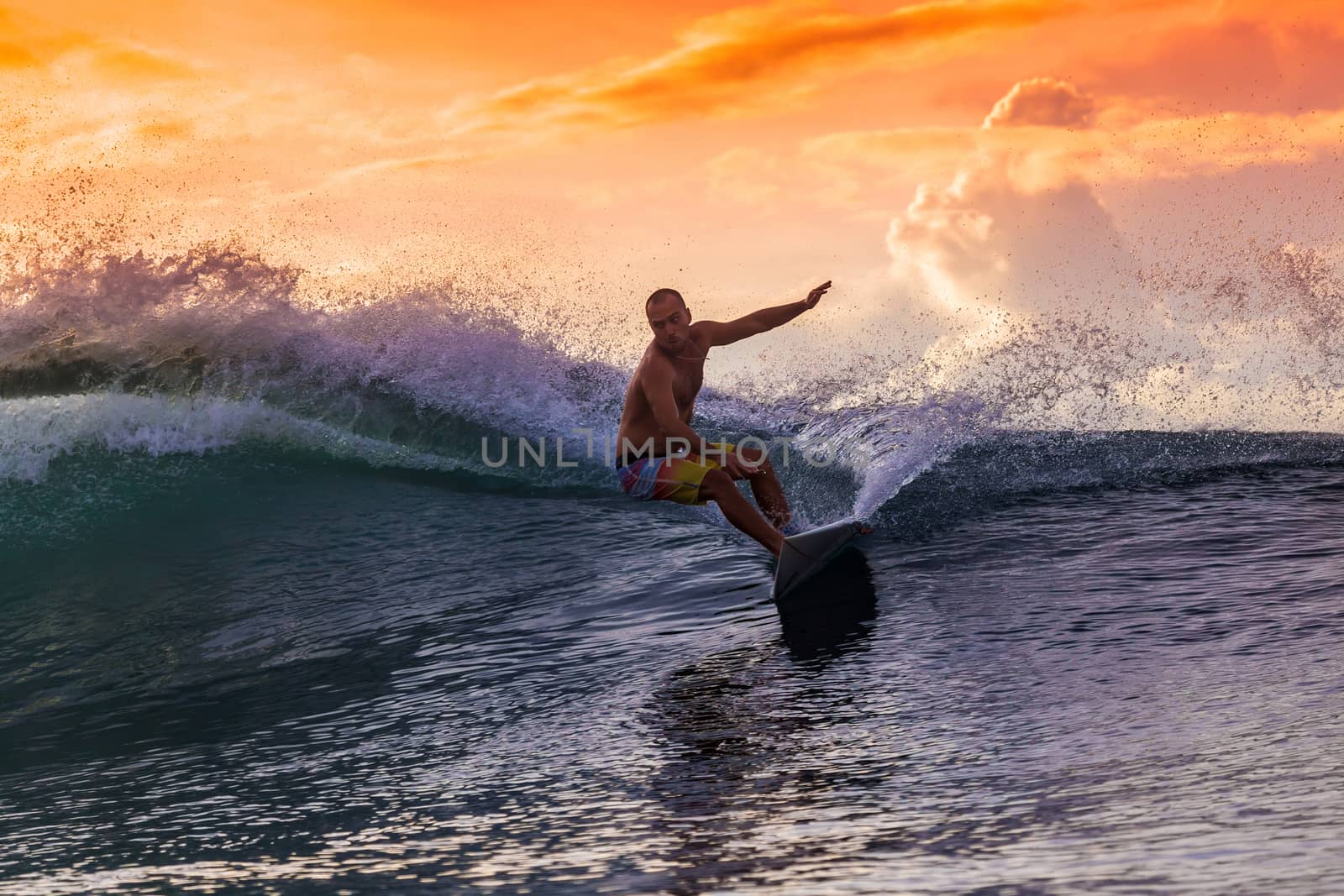 Surfer on Amazing Wave at sunset time, Bali island.