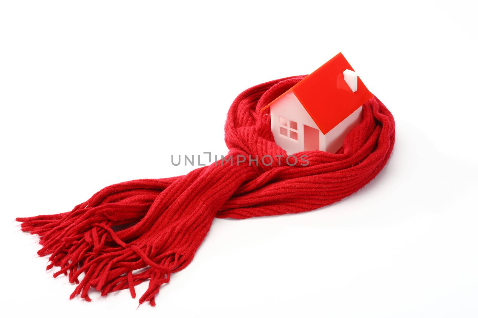 Model of house wrapped in red scarf over white