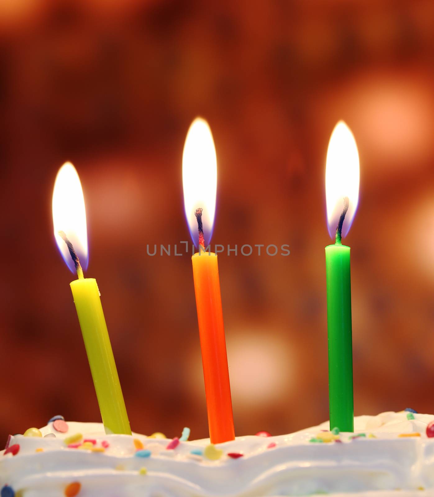 Three lit birthday candles close up, shallow dof