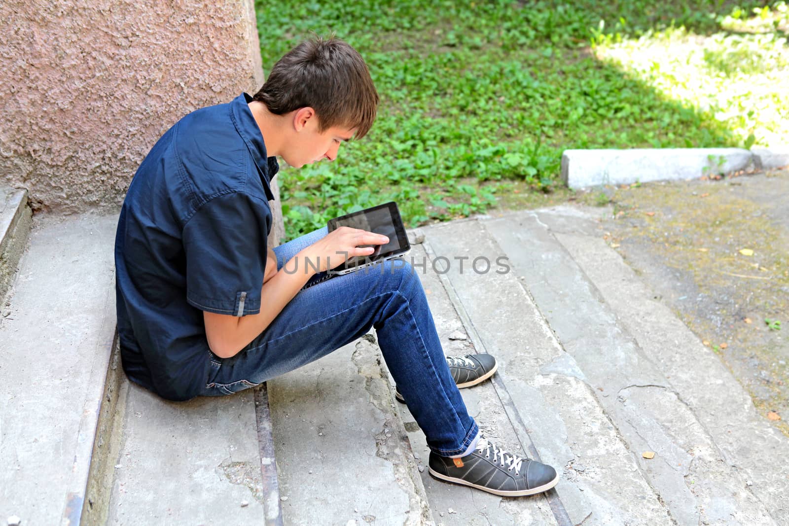 Teenager with Tablet Computer on the landing steps